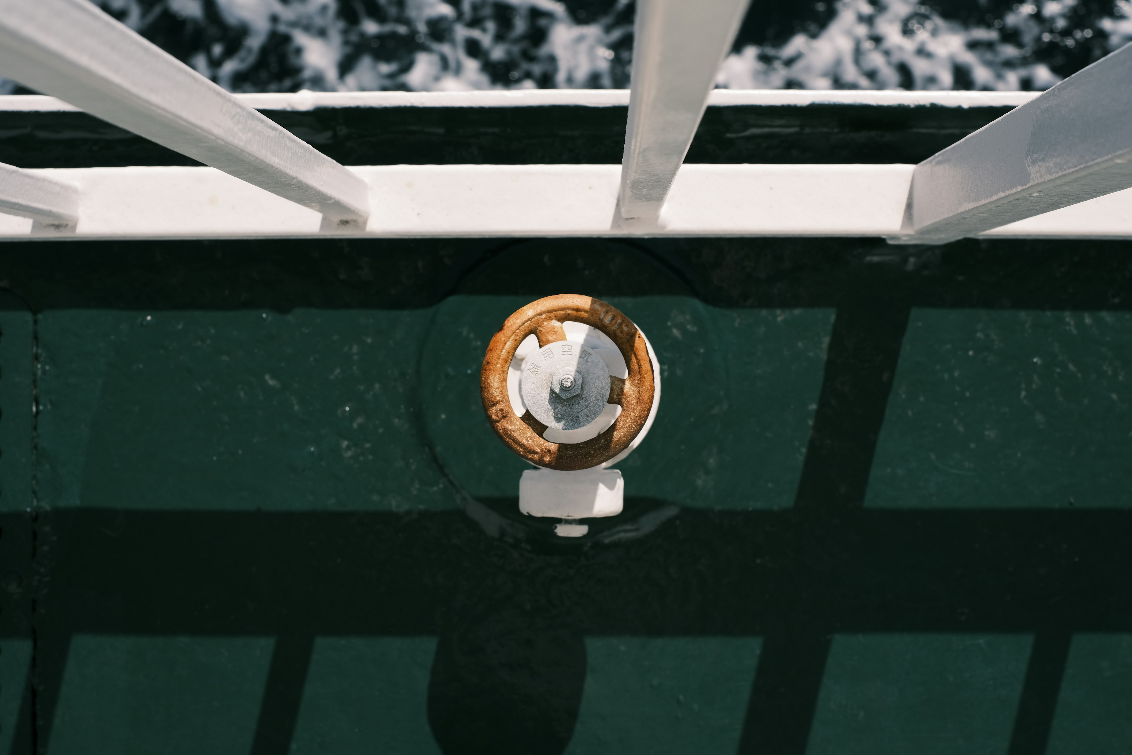 Aerial view of a lifebuoy on a ship's deck with railing