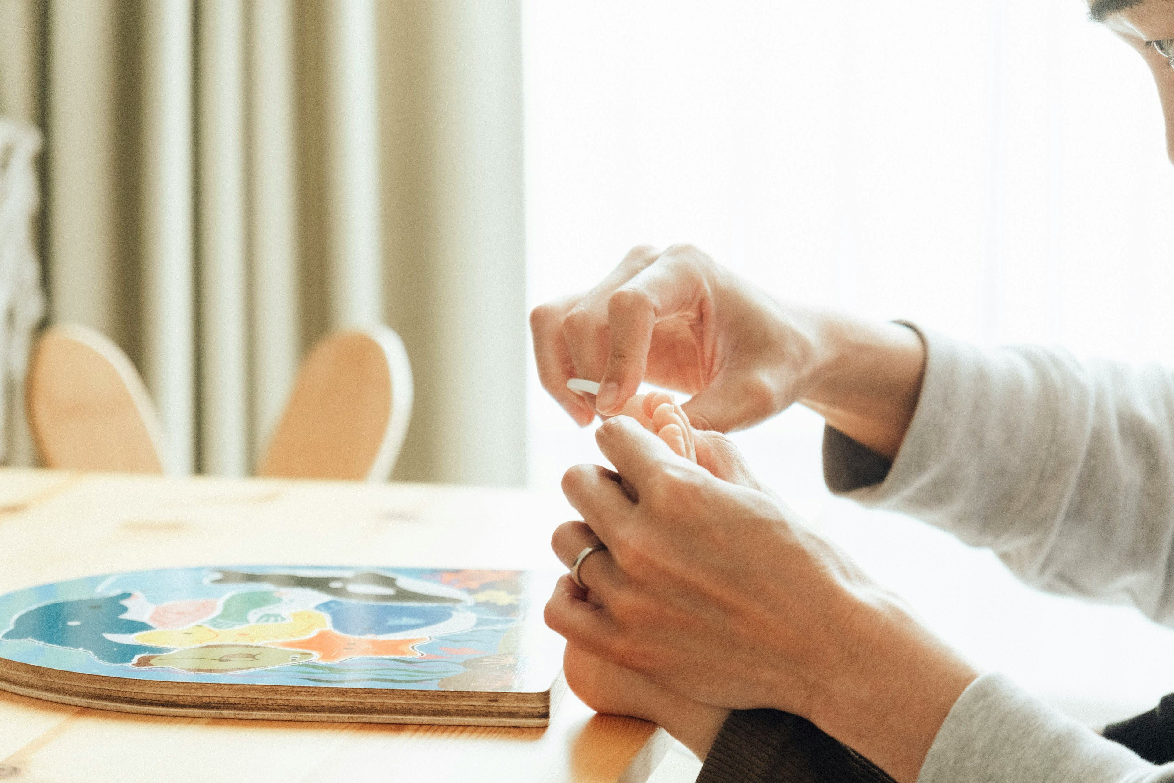 Image of a person assembling a puzzle with hands