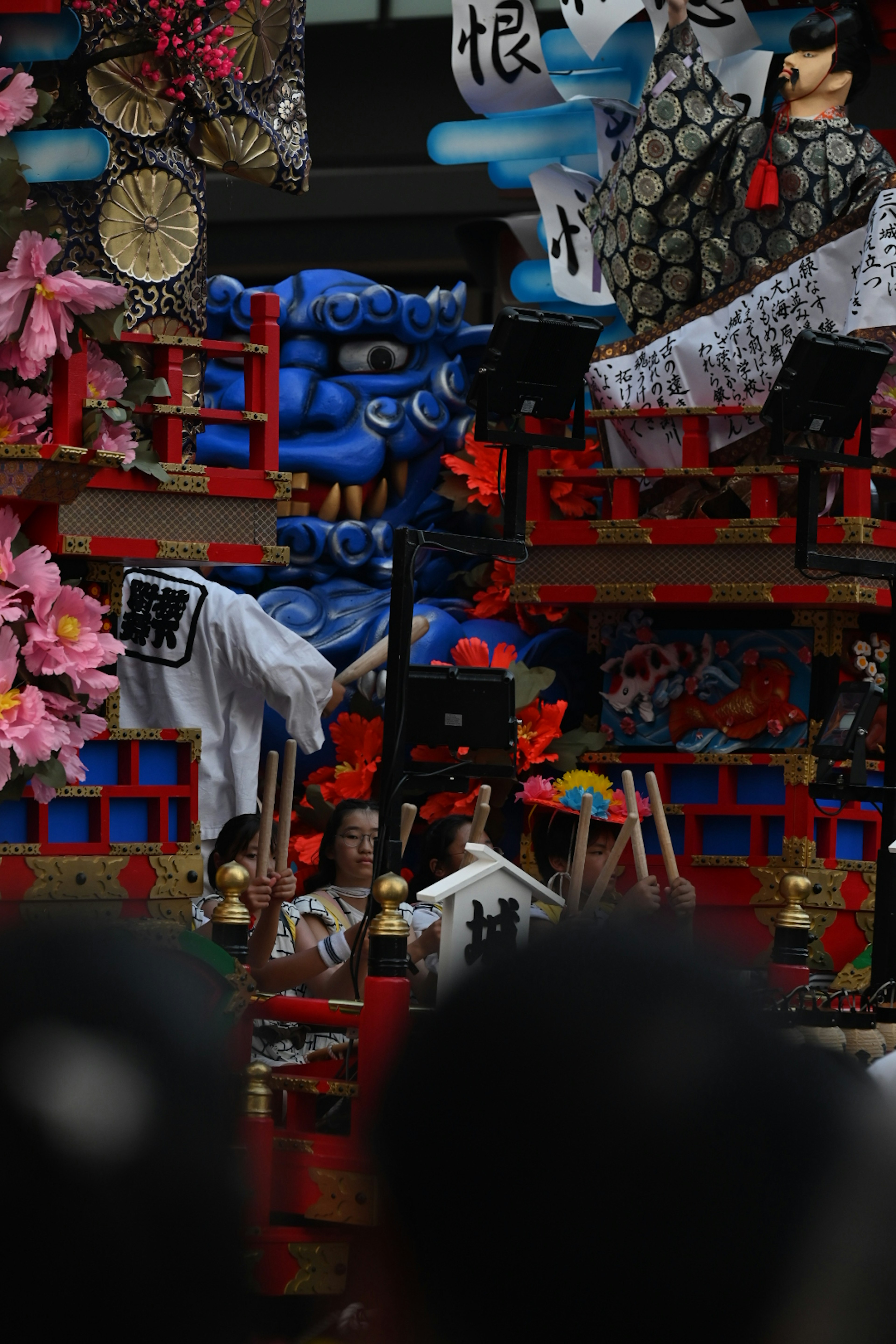 Carroza de festival decorada con una figura de demonio azul y ornamentos vibrantes