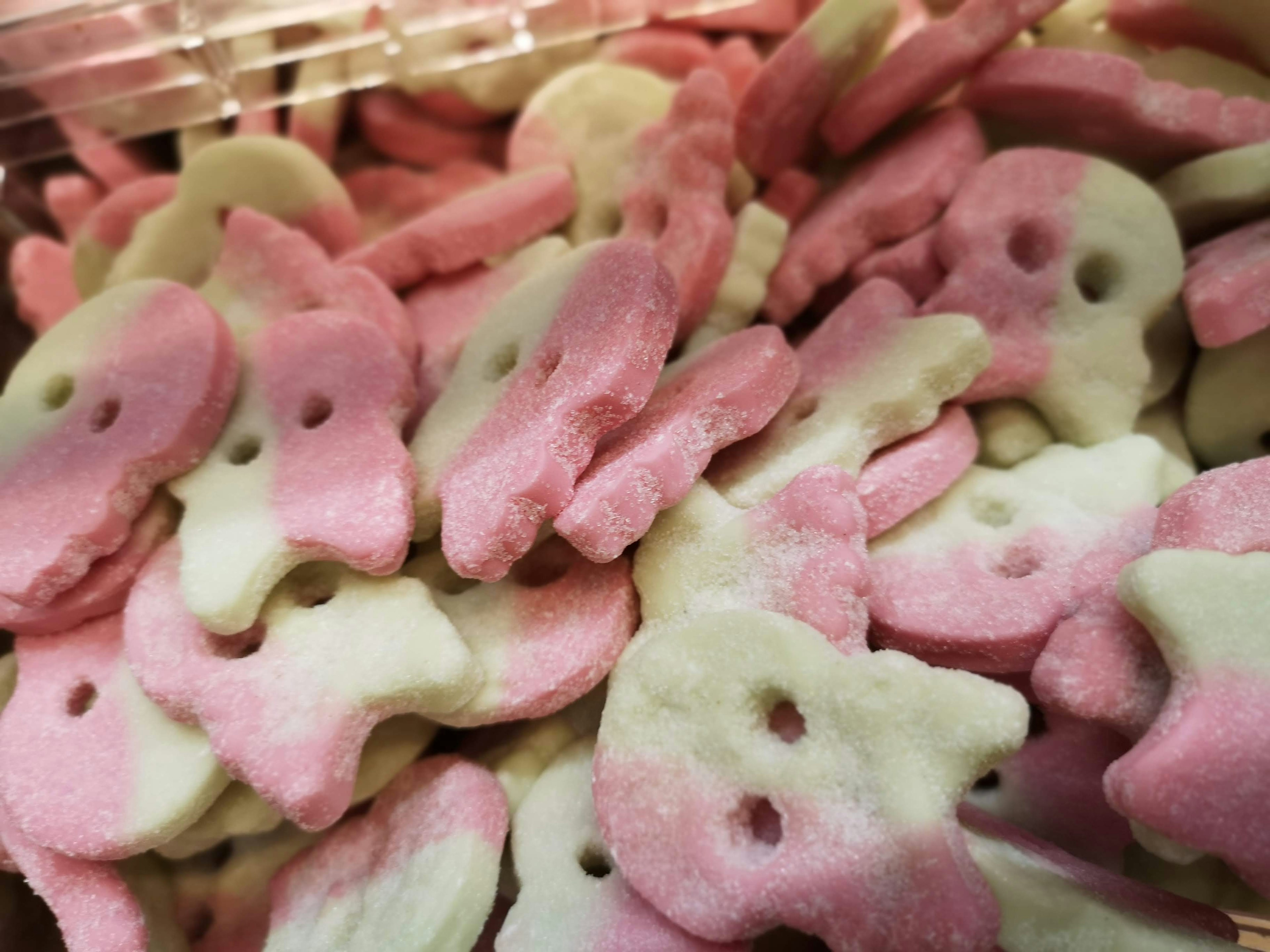 Colorful pink and white rabbit-shaped candies piled together