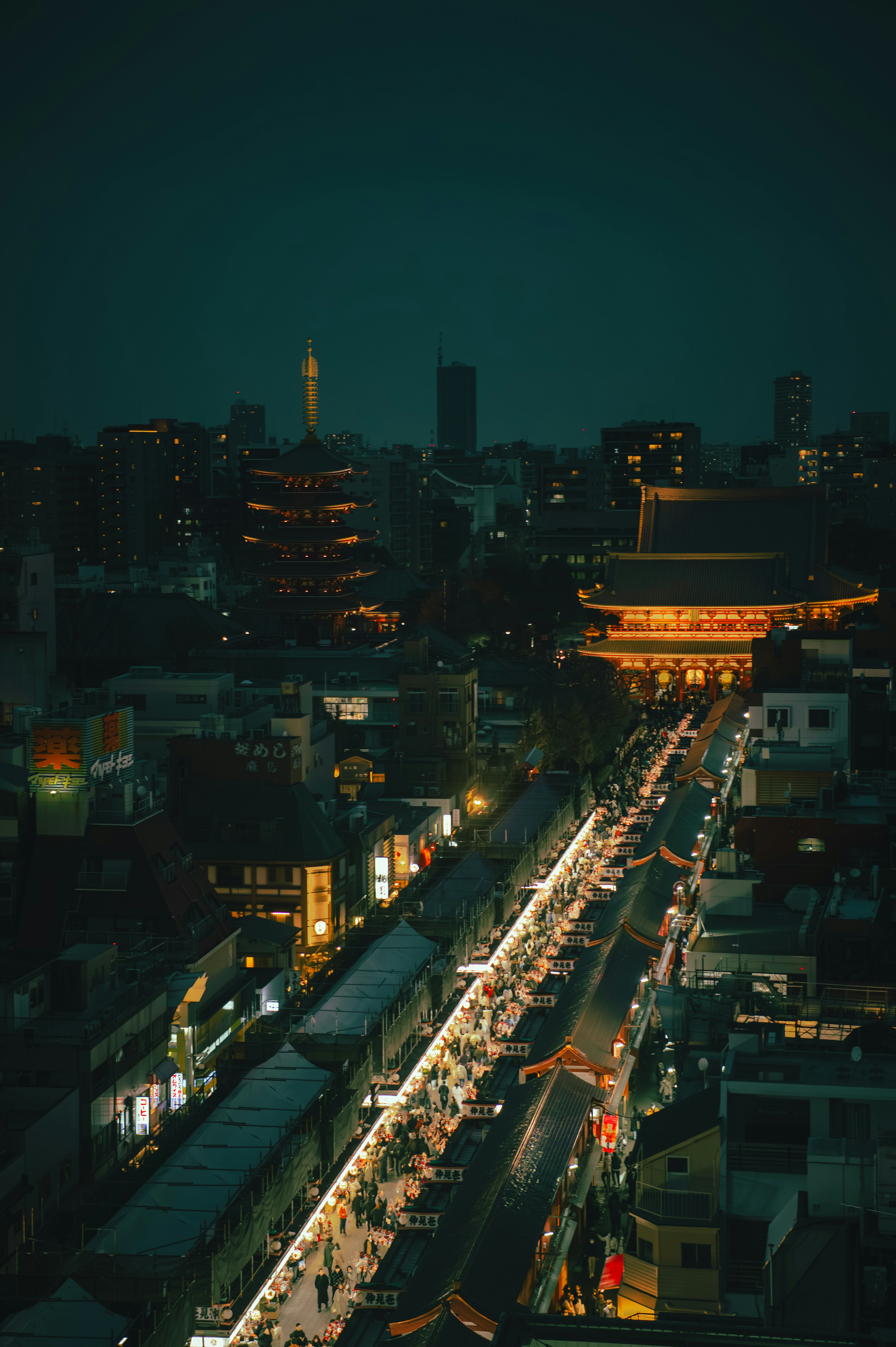 Nighttime cityscape with illuminated street stalls