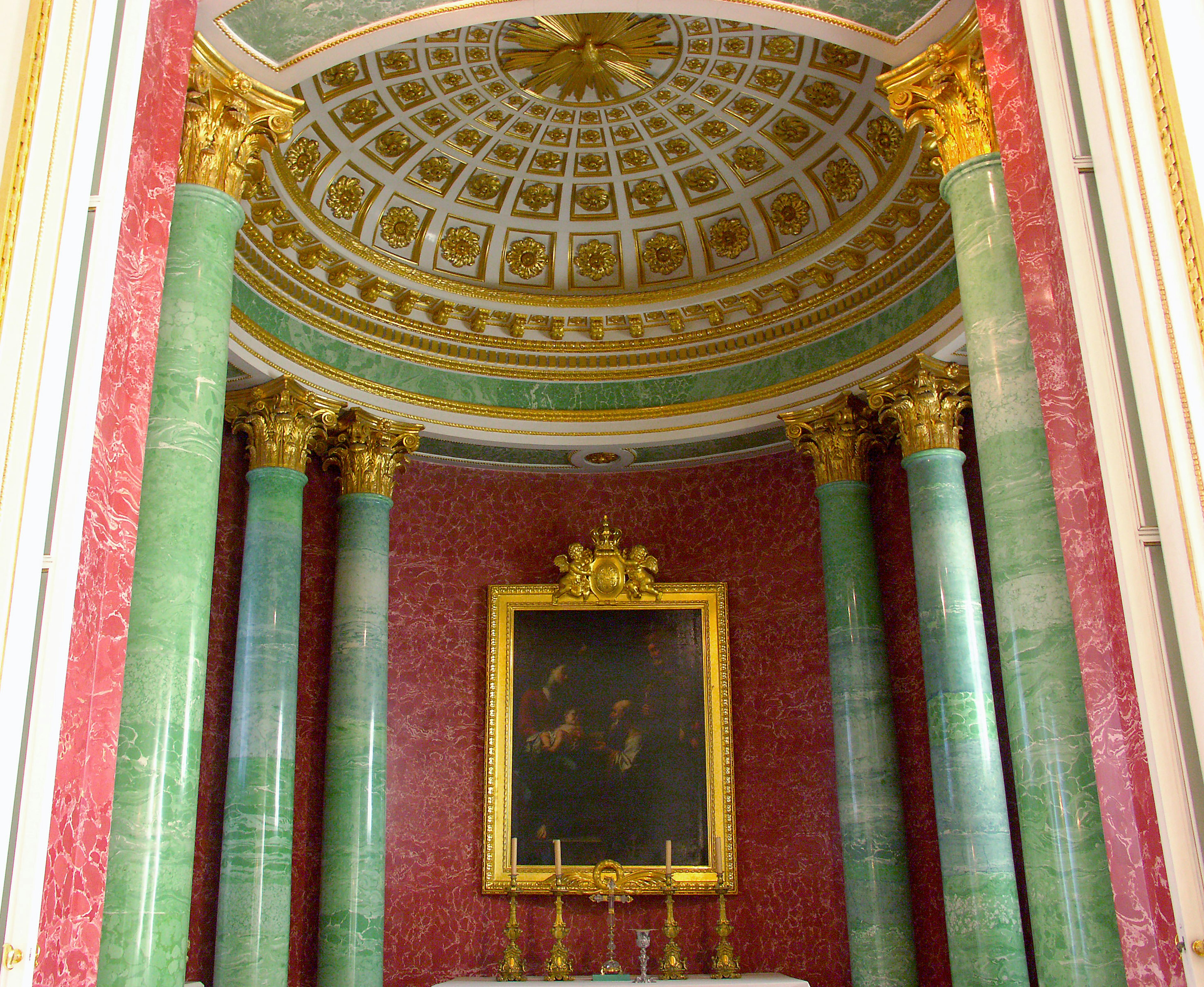 Interior of an opulent room with green columns and golden decorations red walls and a beautiful ceiling design