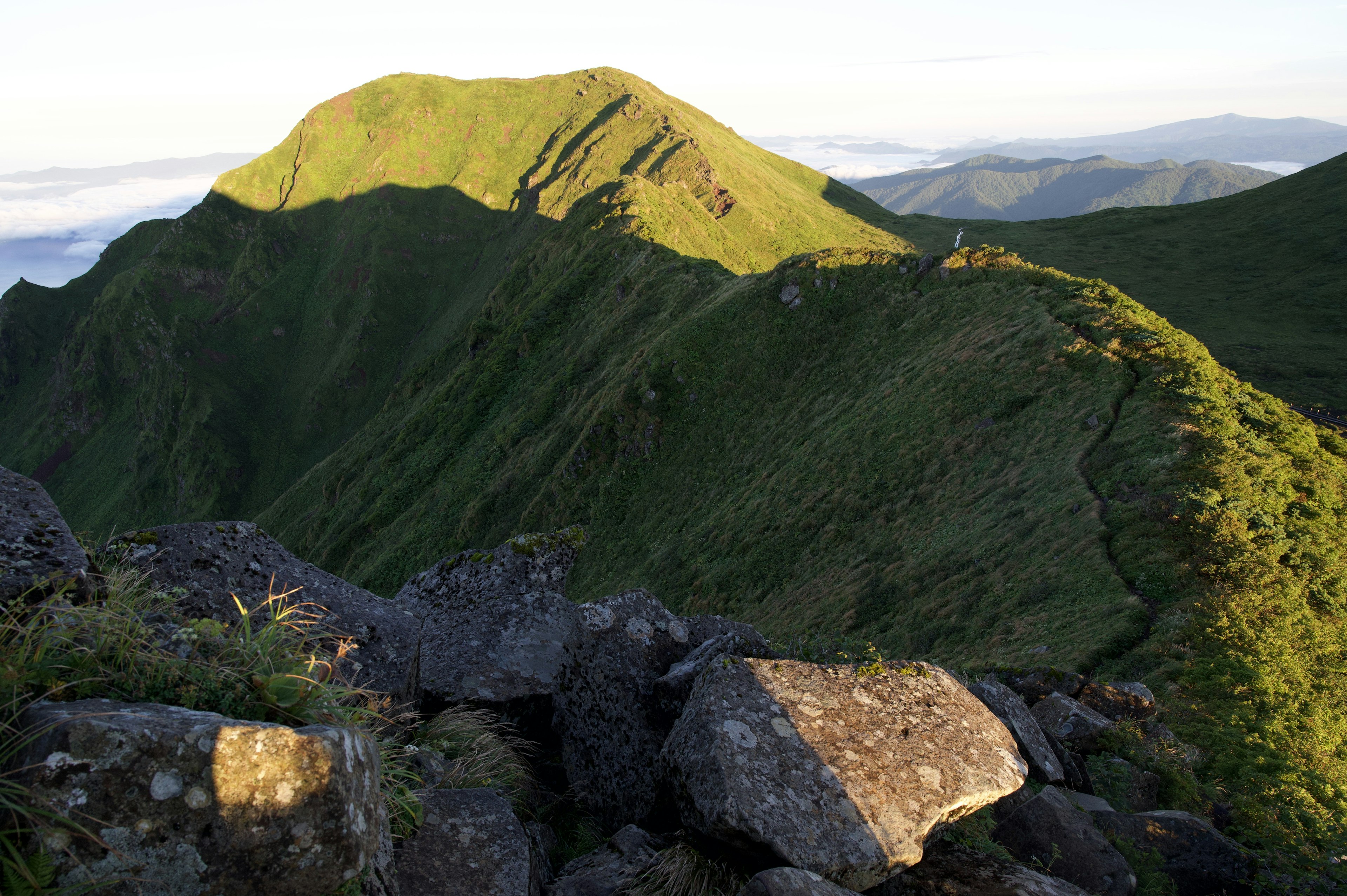 Lush green mountains with rocky terrain