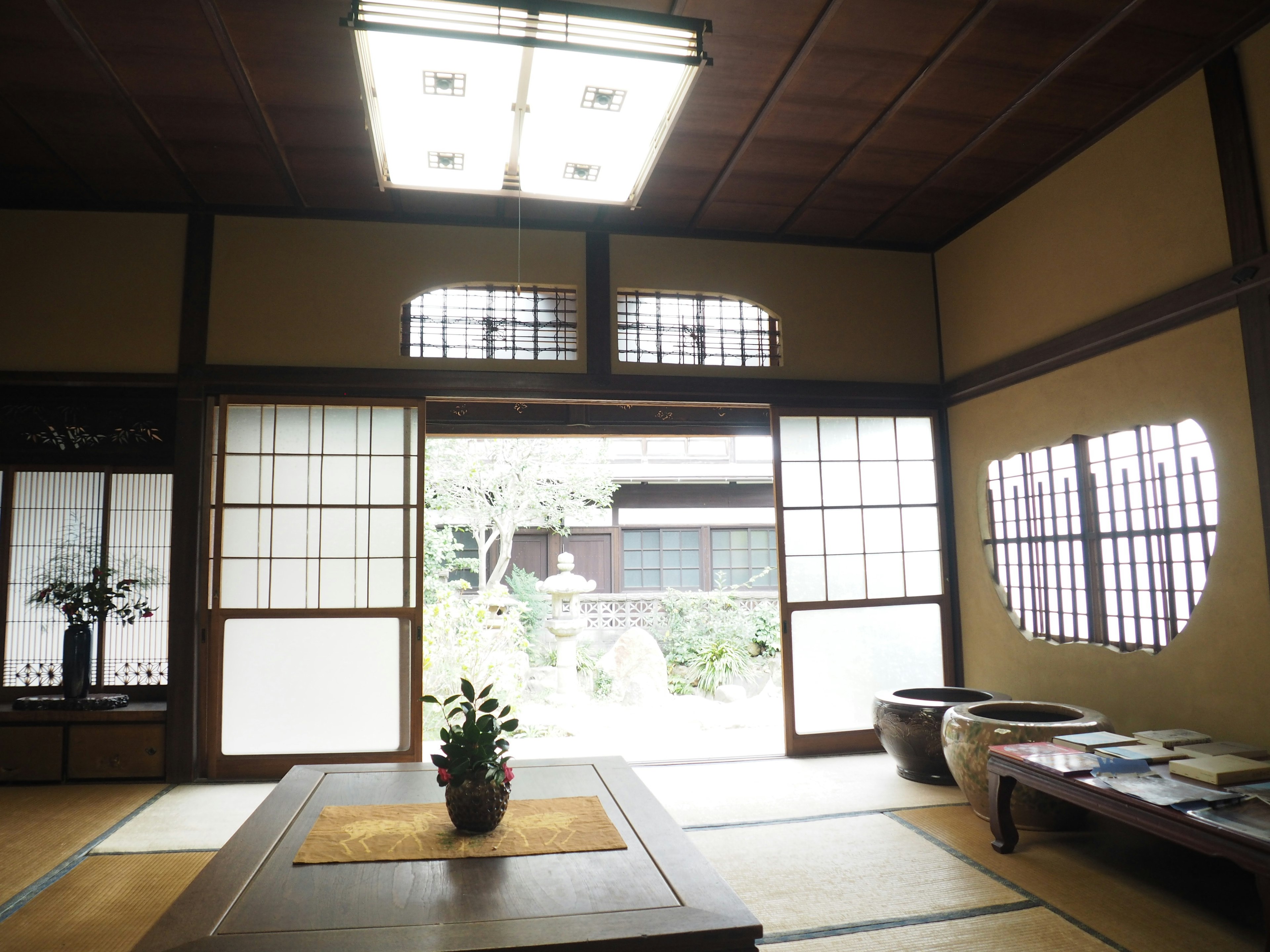 Interior of a traditional Japanese room with tatami mats shoji screens and a view of the garden