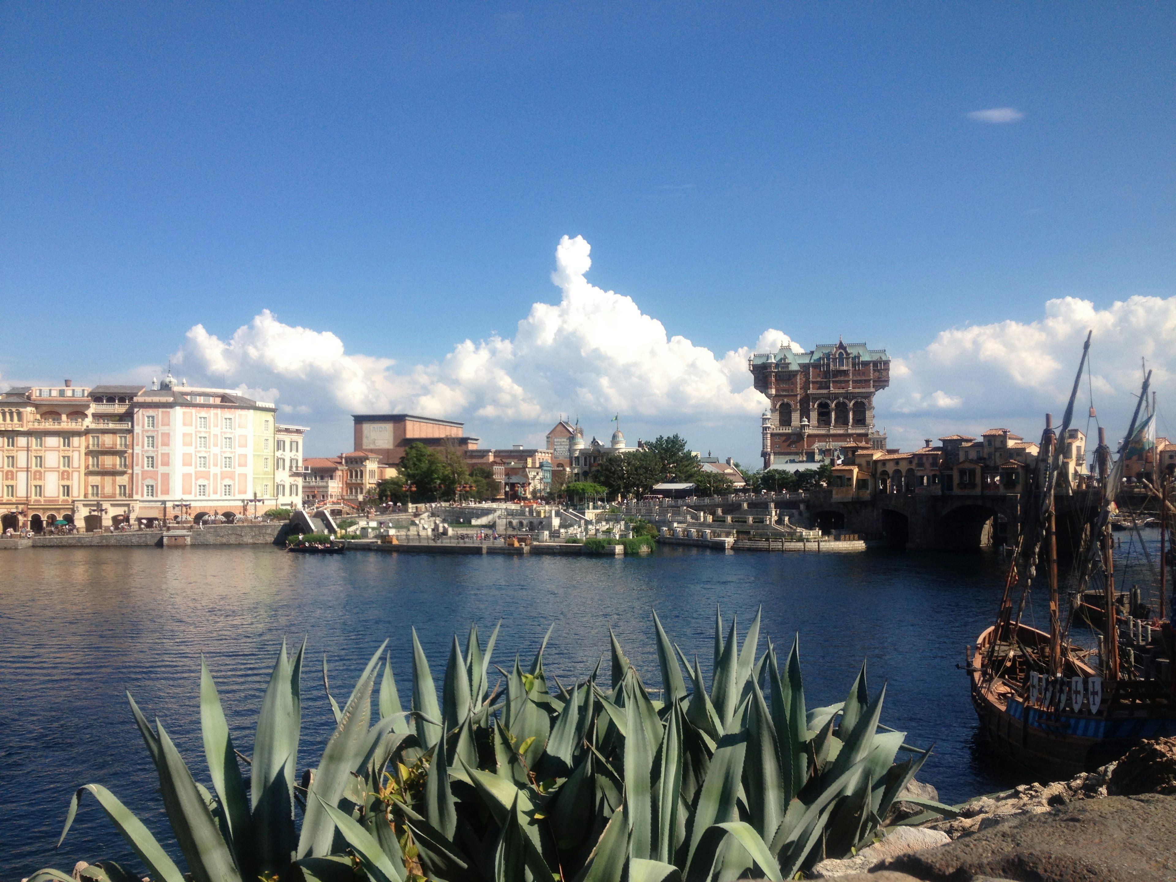 Scenic waterfront view featuring blue sky and lush greenery