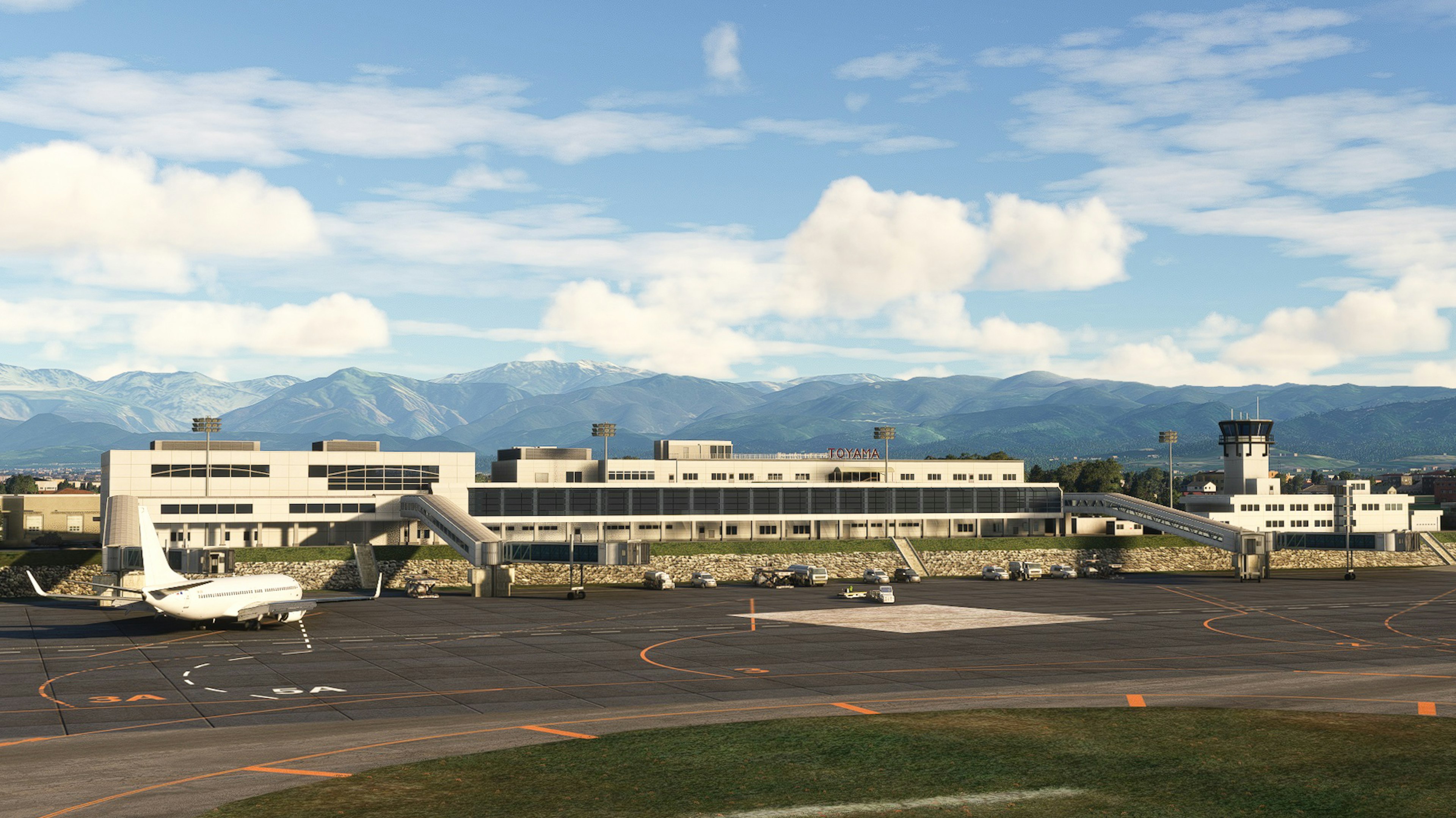 Vue du terminal de l'aéroport et de la piste avec des montagnes en arrière-plan