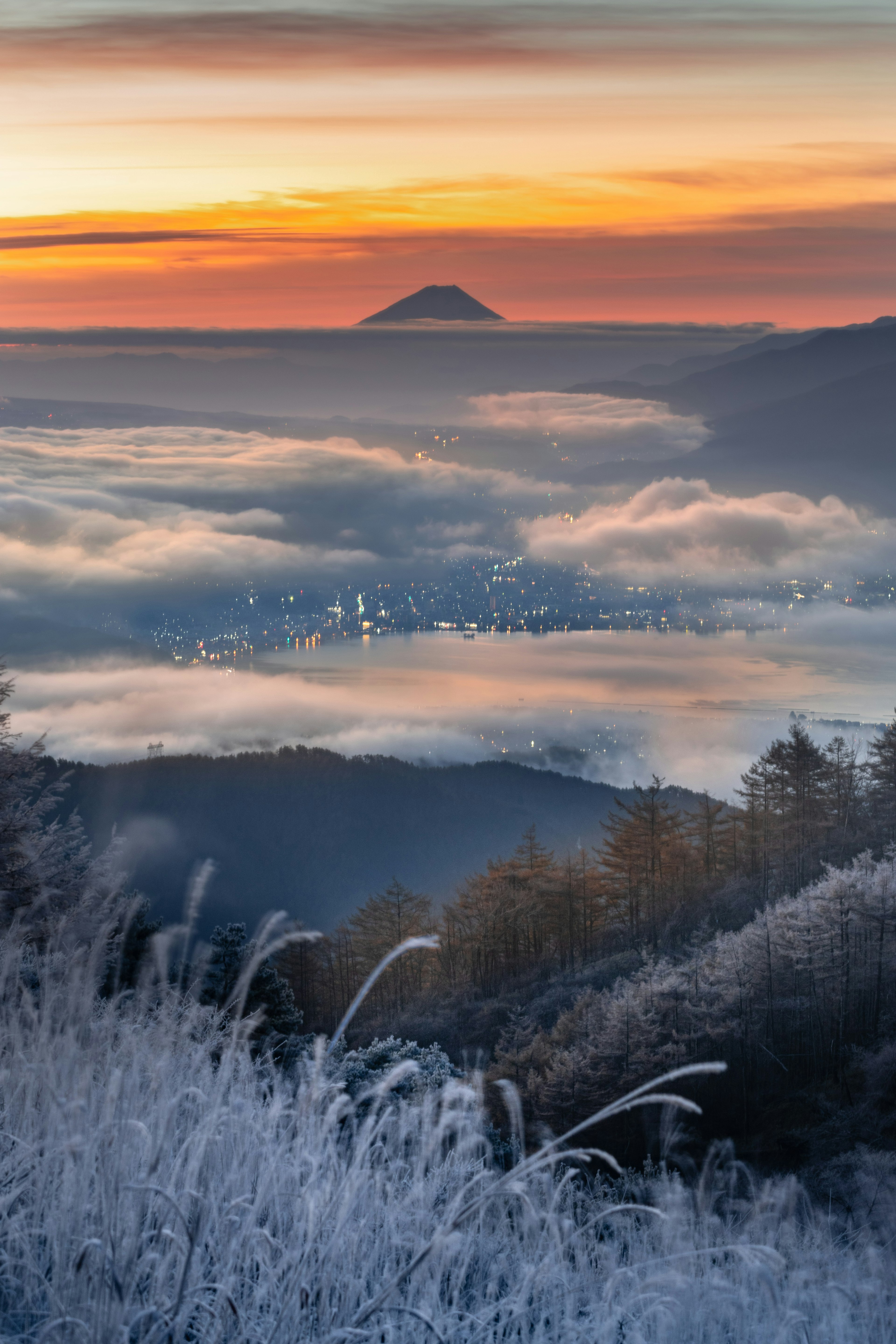 Scenic view of a mountain shrouded in mist with a colorful sunrise