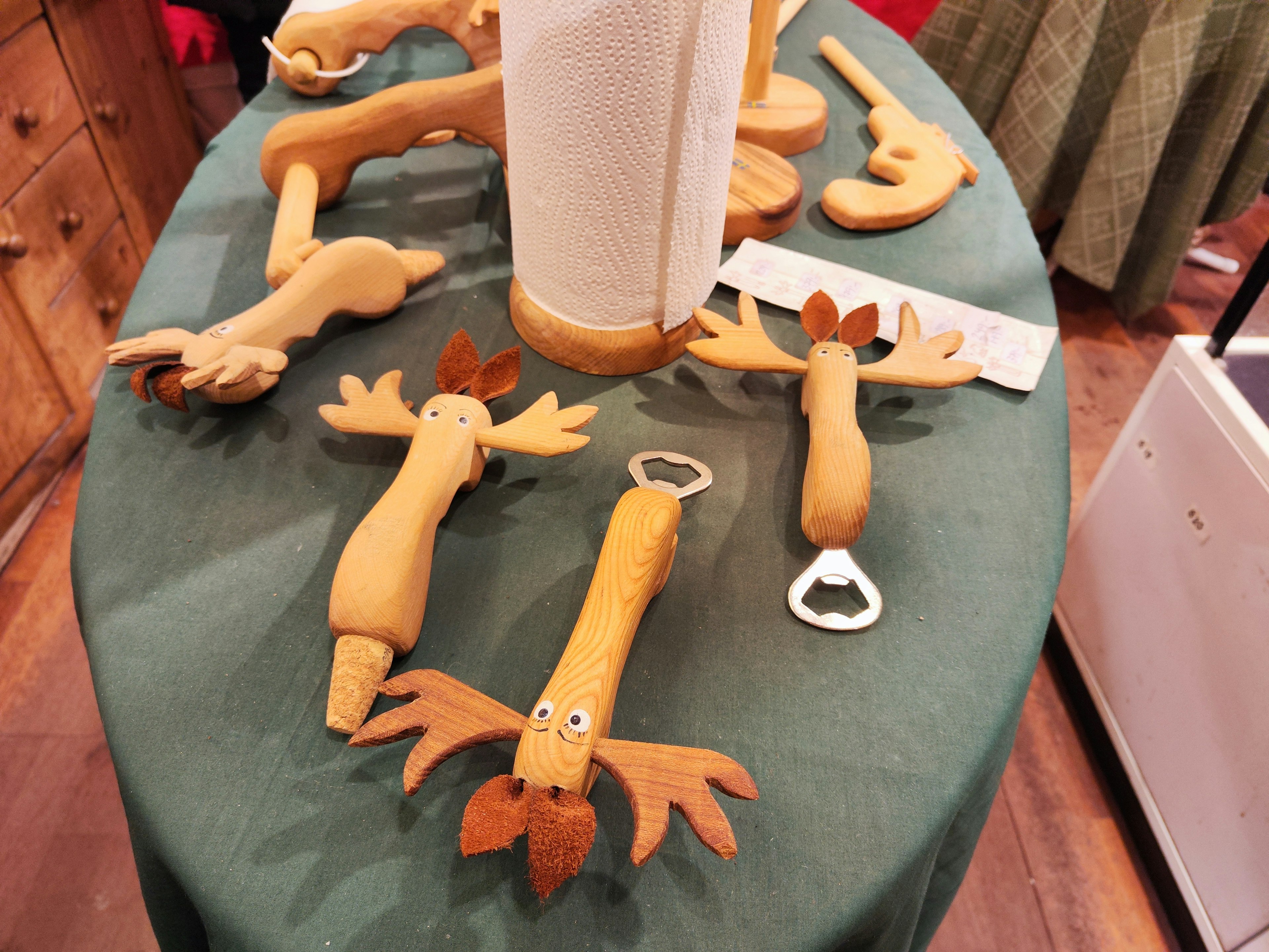 Wooden moose-shaped kitchen tools arranged on a table