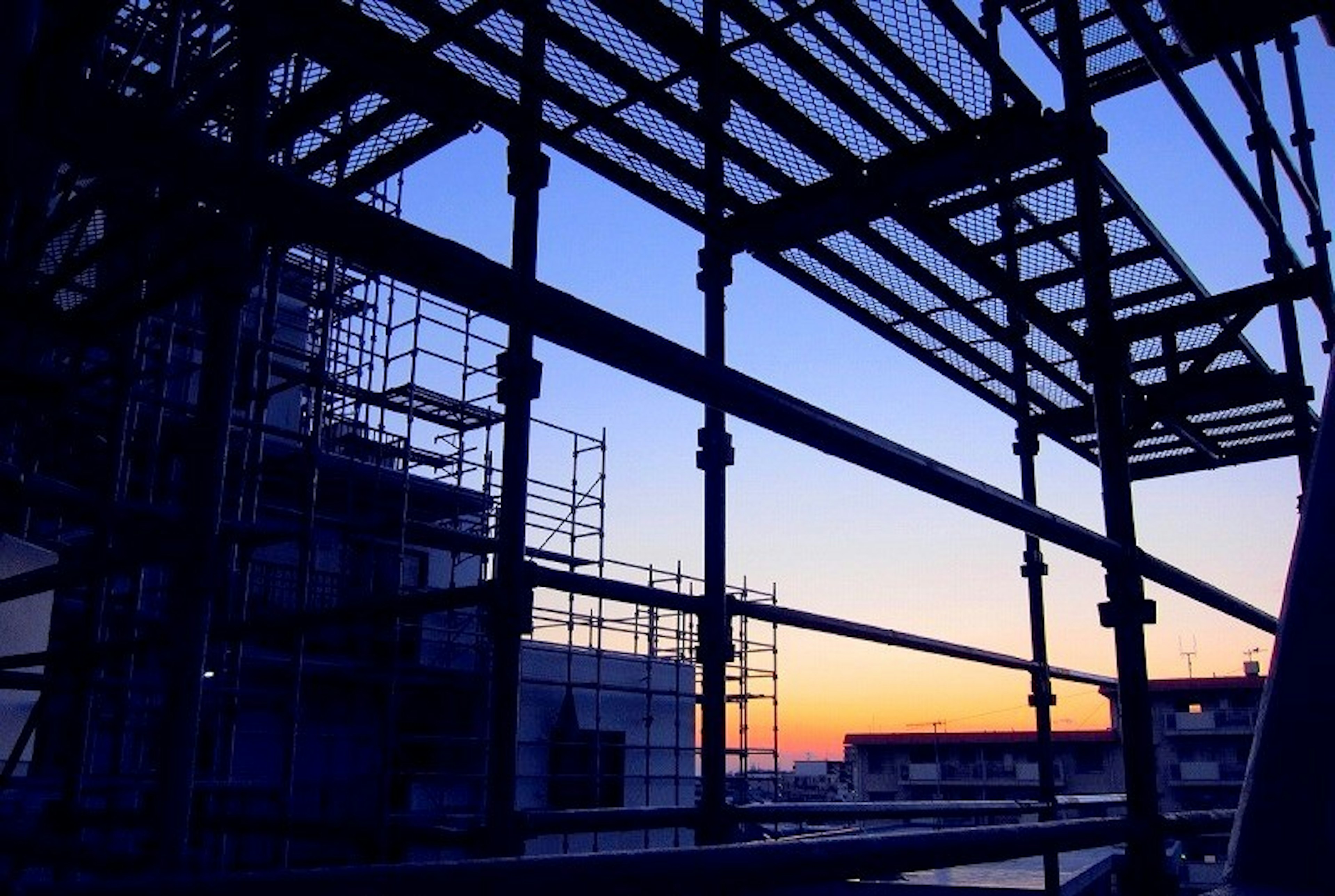 Silhouette of scaffolding against a sunset background