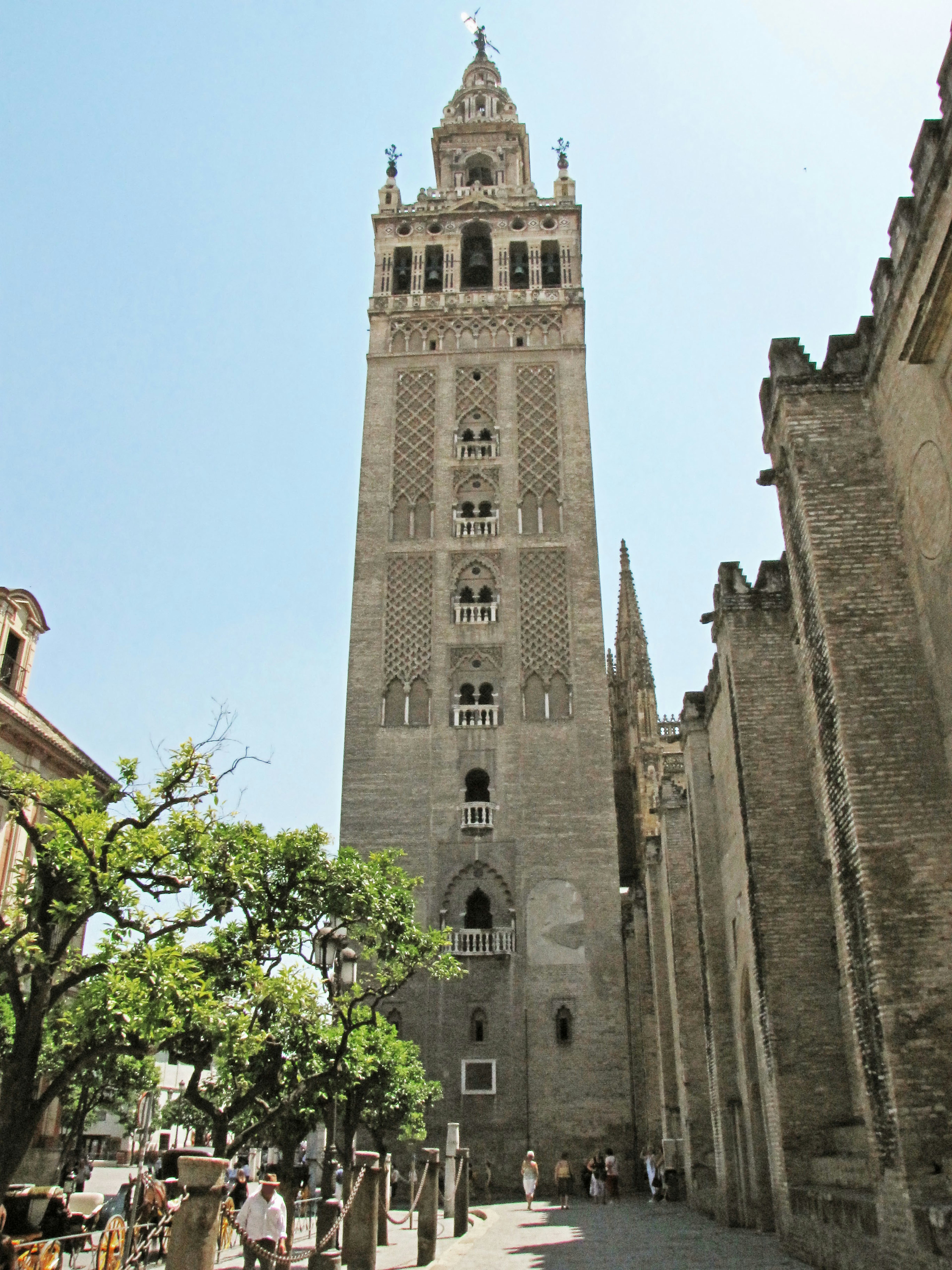 Photo of the Giralda Tower in Seville with surrounding buildings