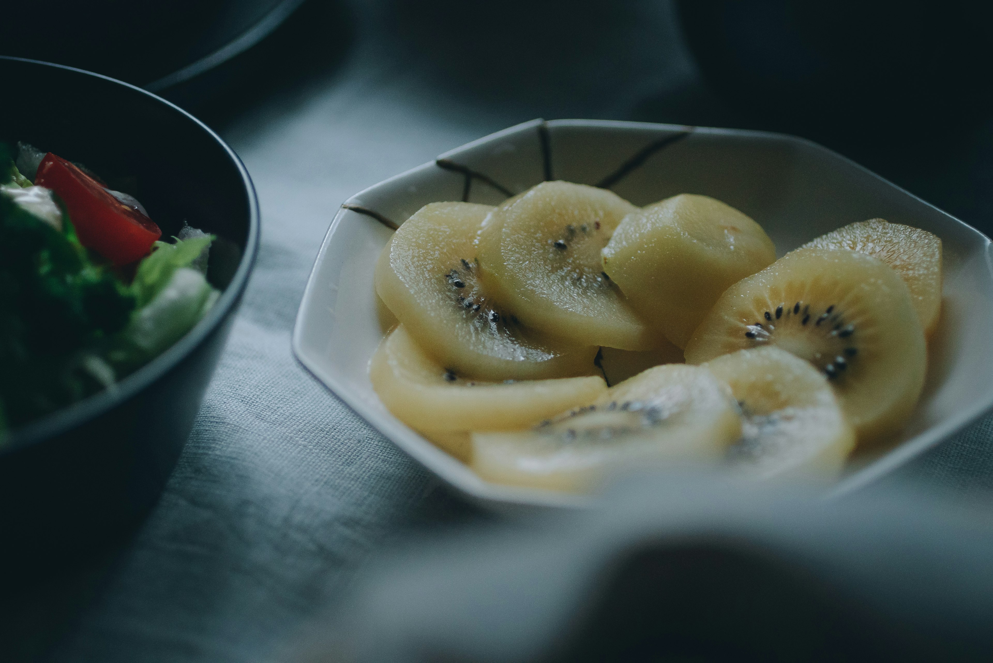 Sliced kiwi arranged in a white dish