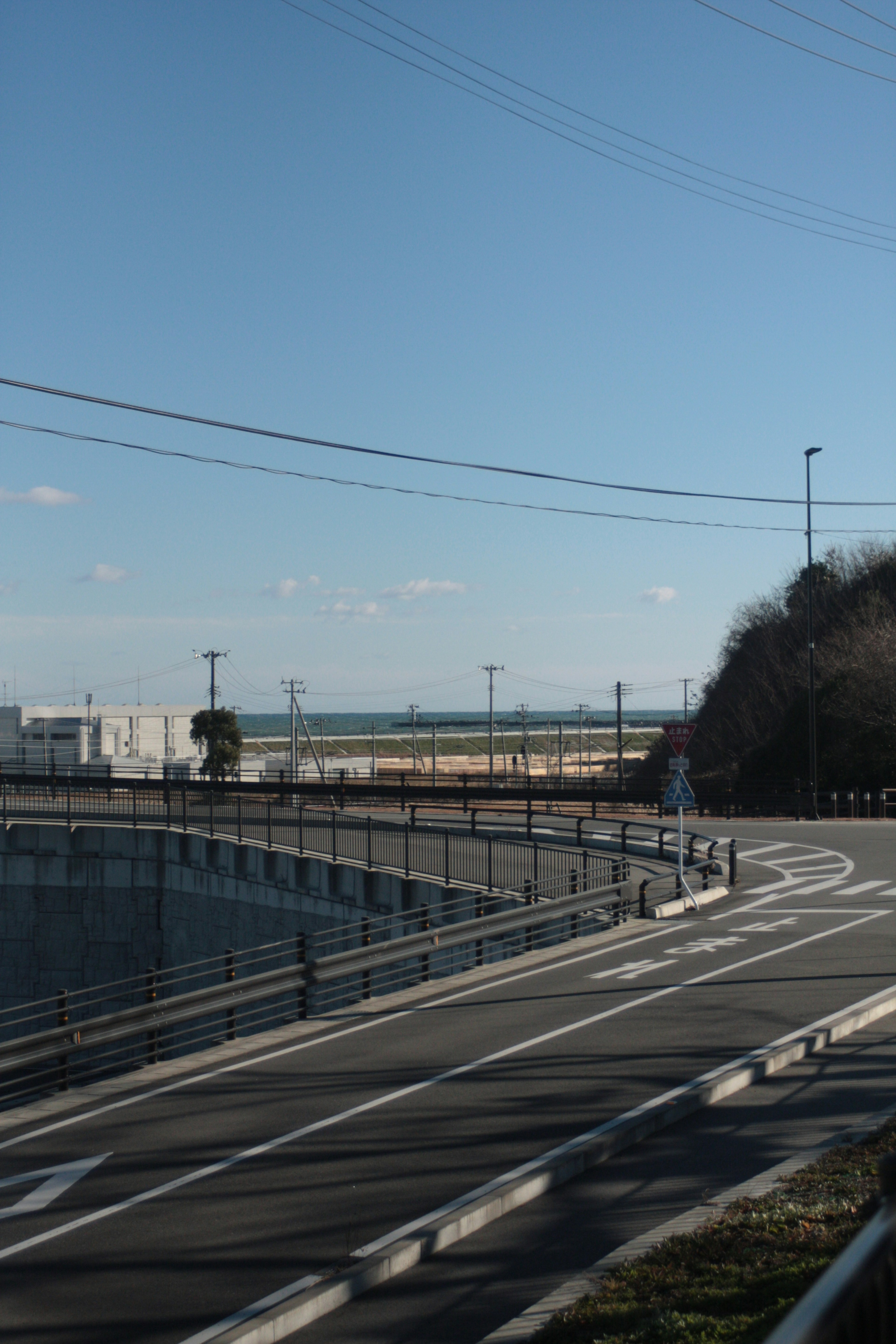 Coastal road with blue sky and distant horizon