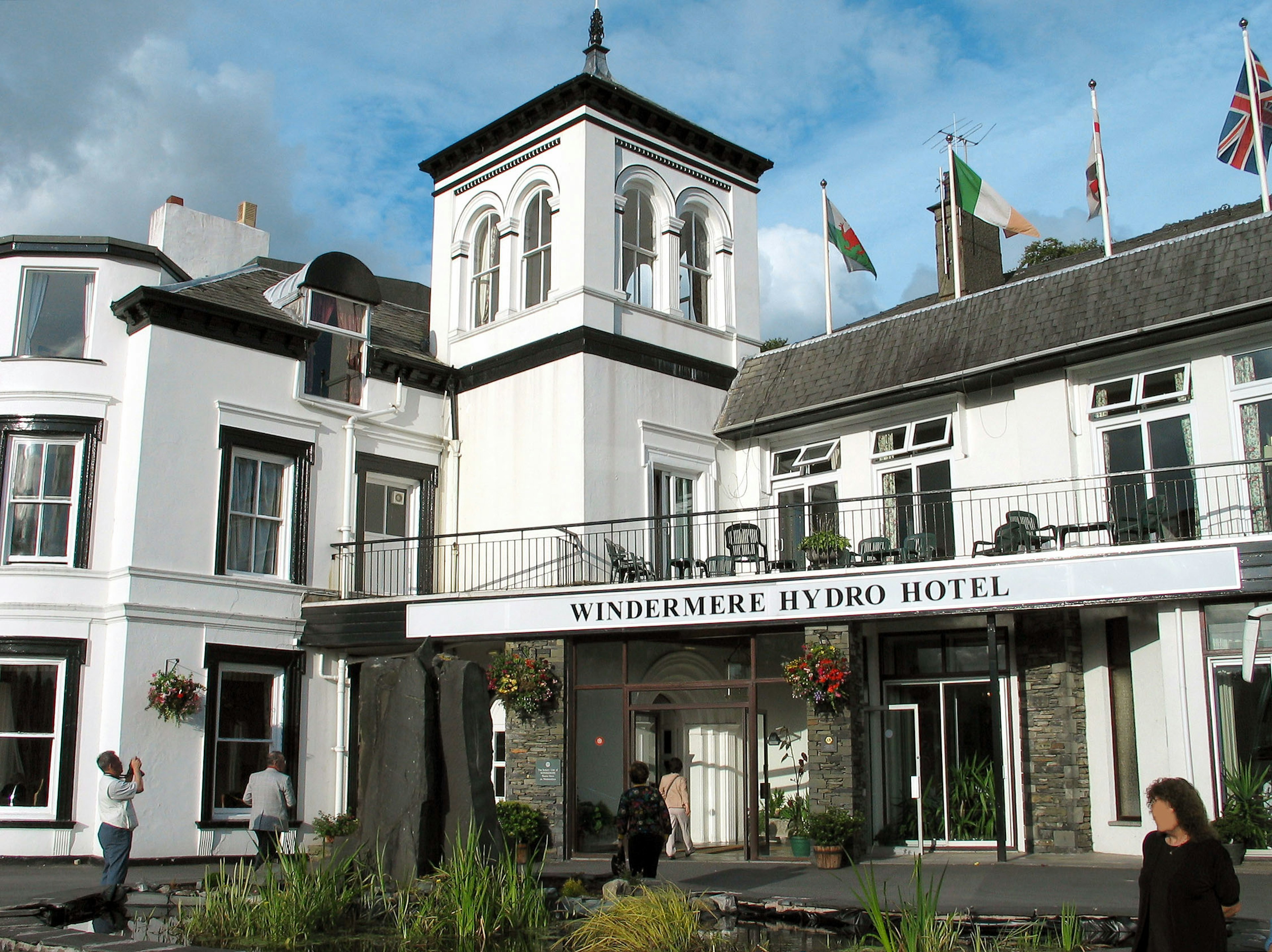 Exterior view of the Windermere Hydro Hotel with flags