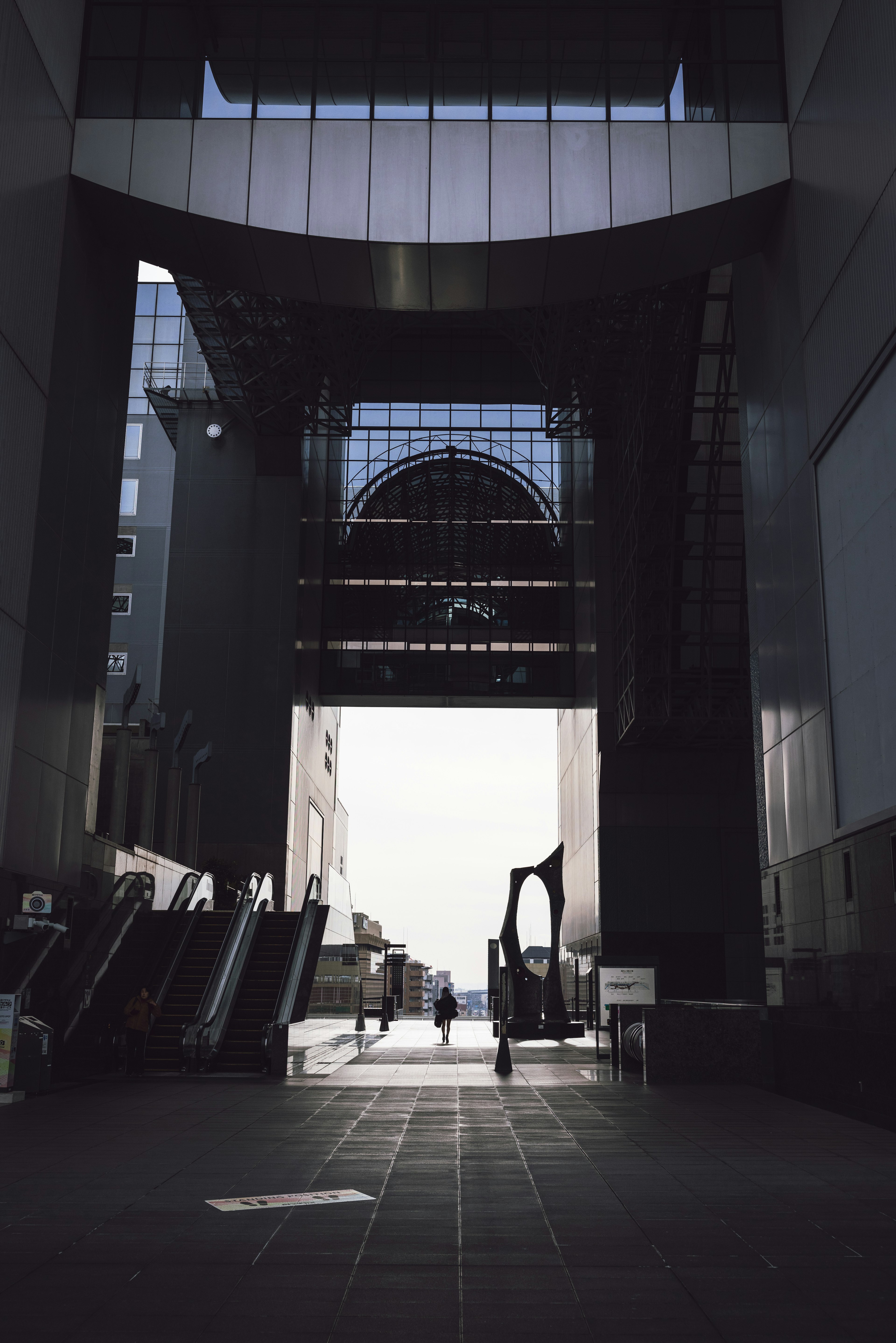 Modern architectural entrance with visible escalators