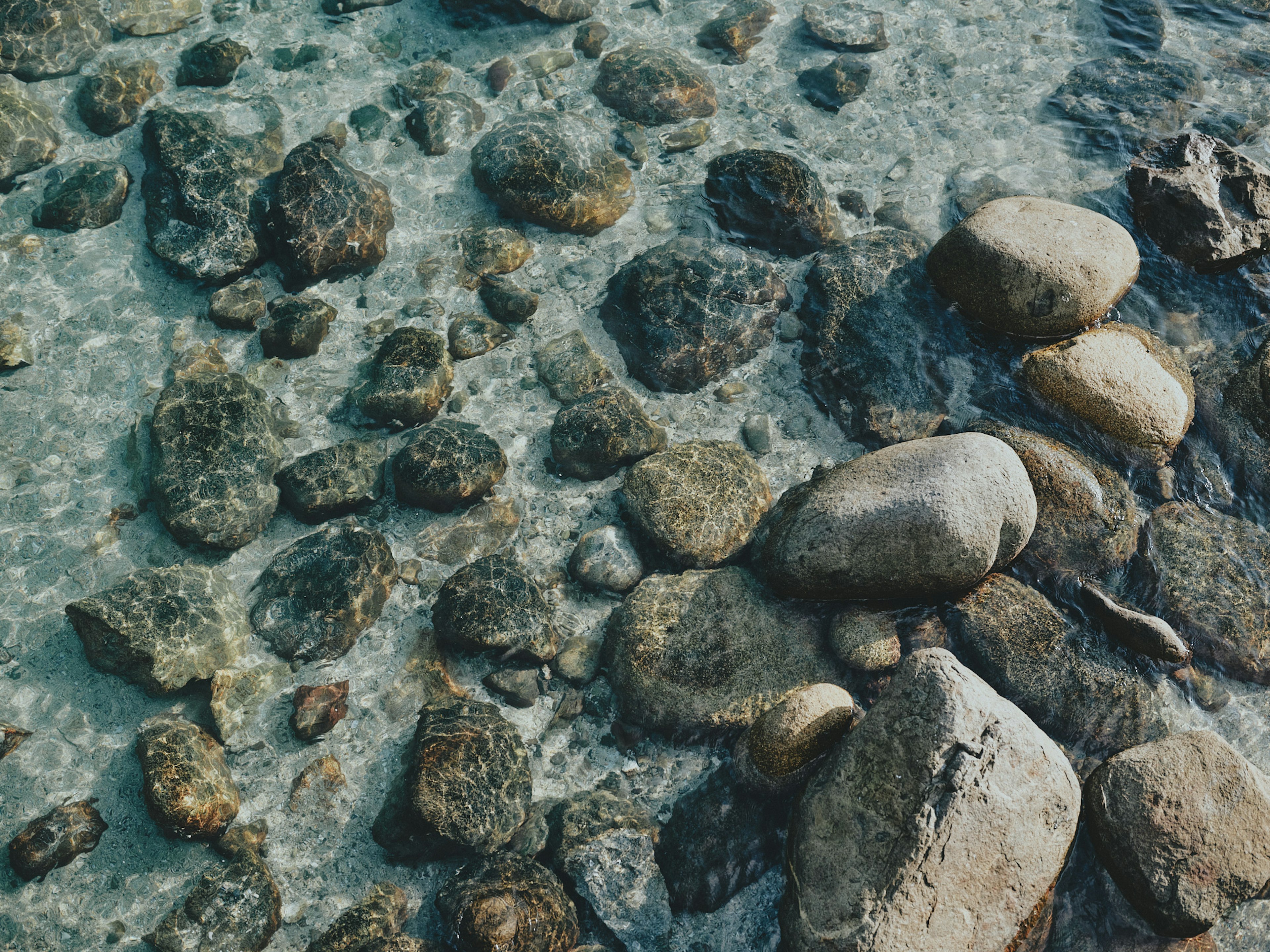 Various shaped stones in clear water