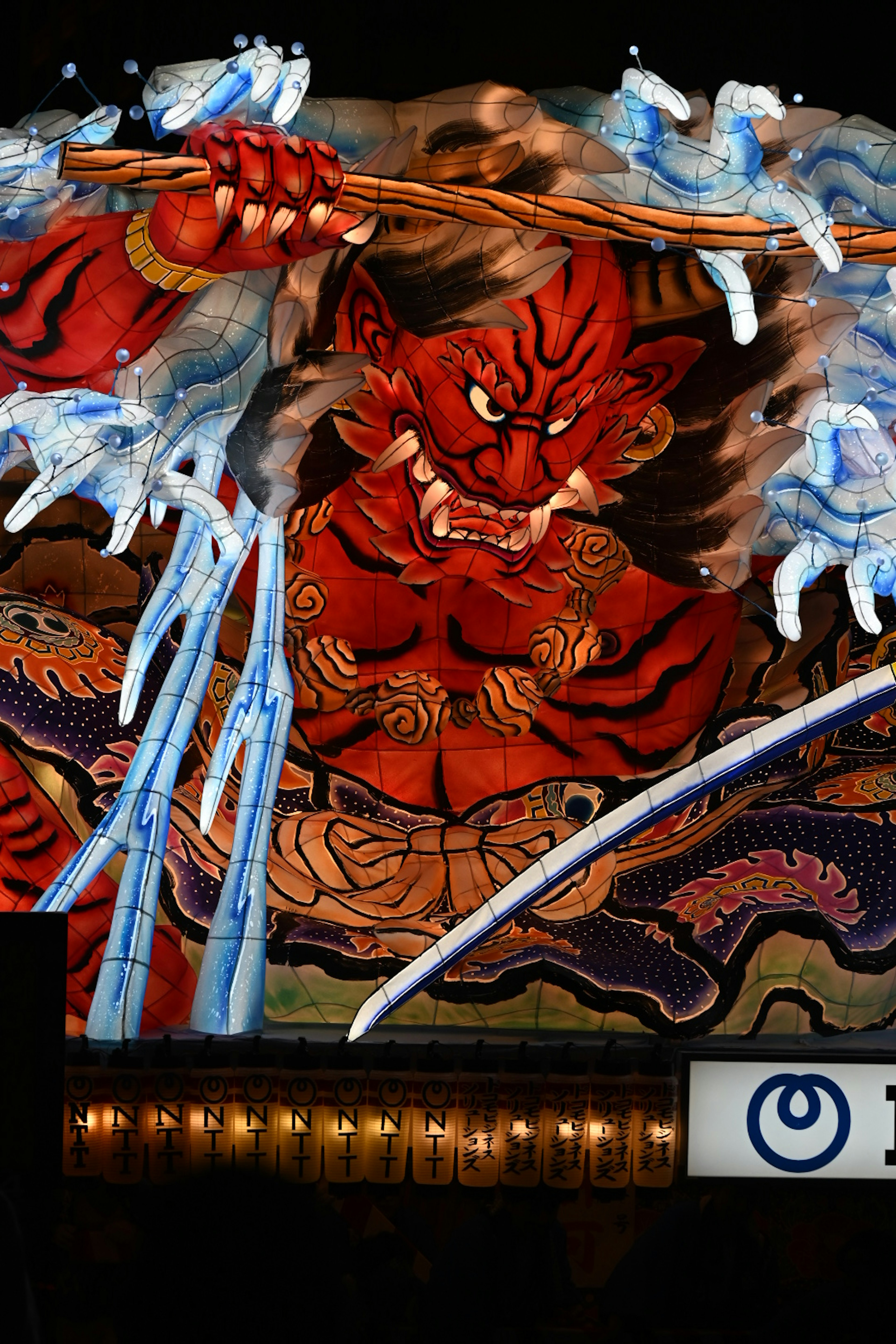 Vibrant red demon controlling water with fierce expression