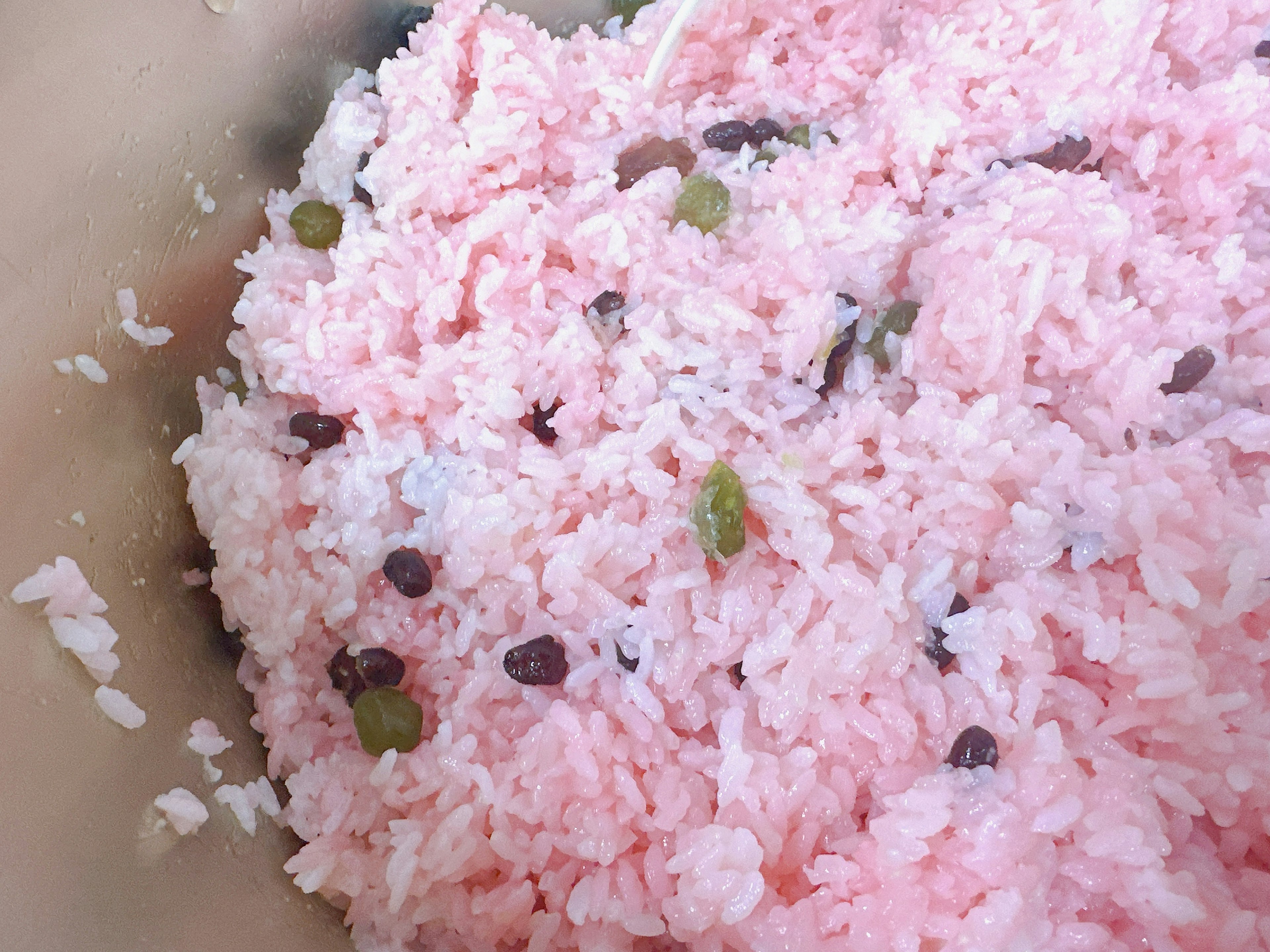 Pink sticky rice mixed with green and black beans