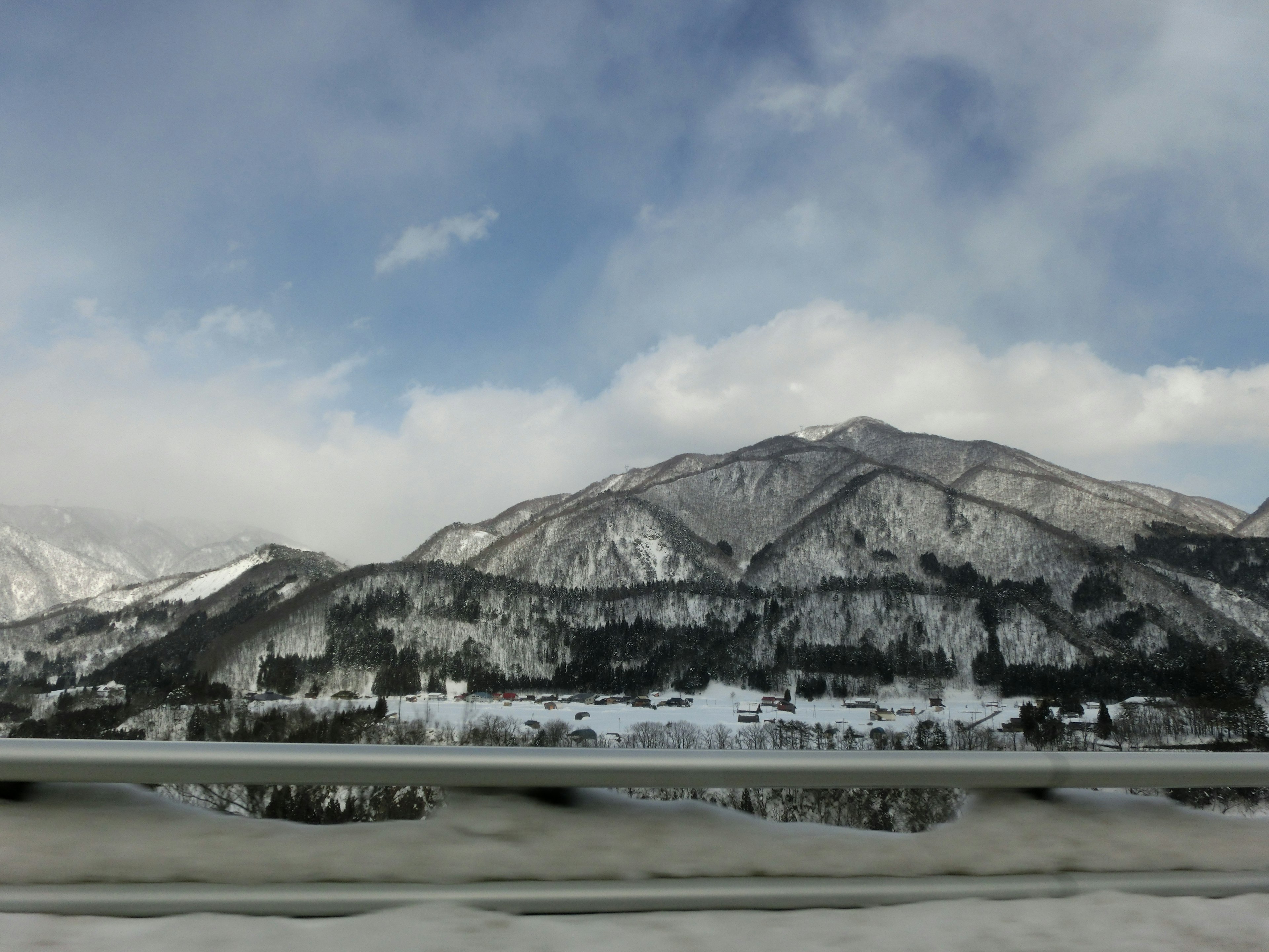 Snow-covered mountains under a blue sky