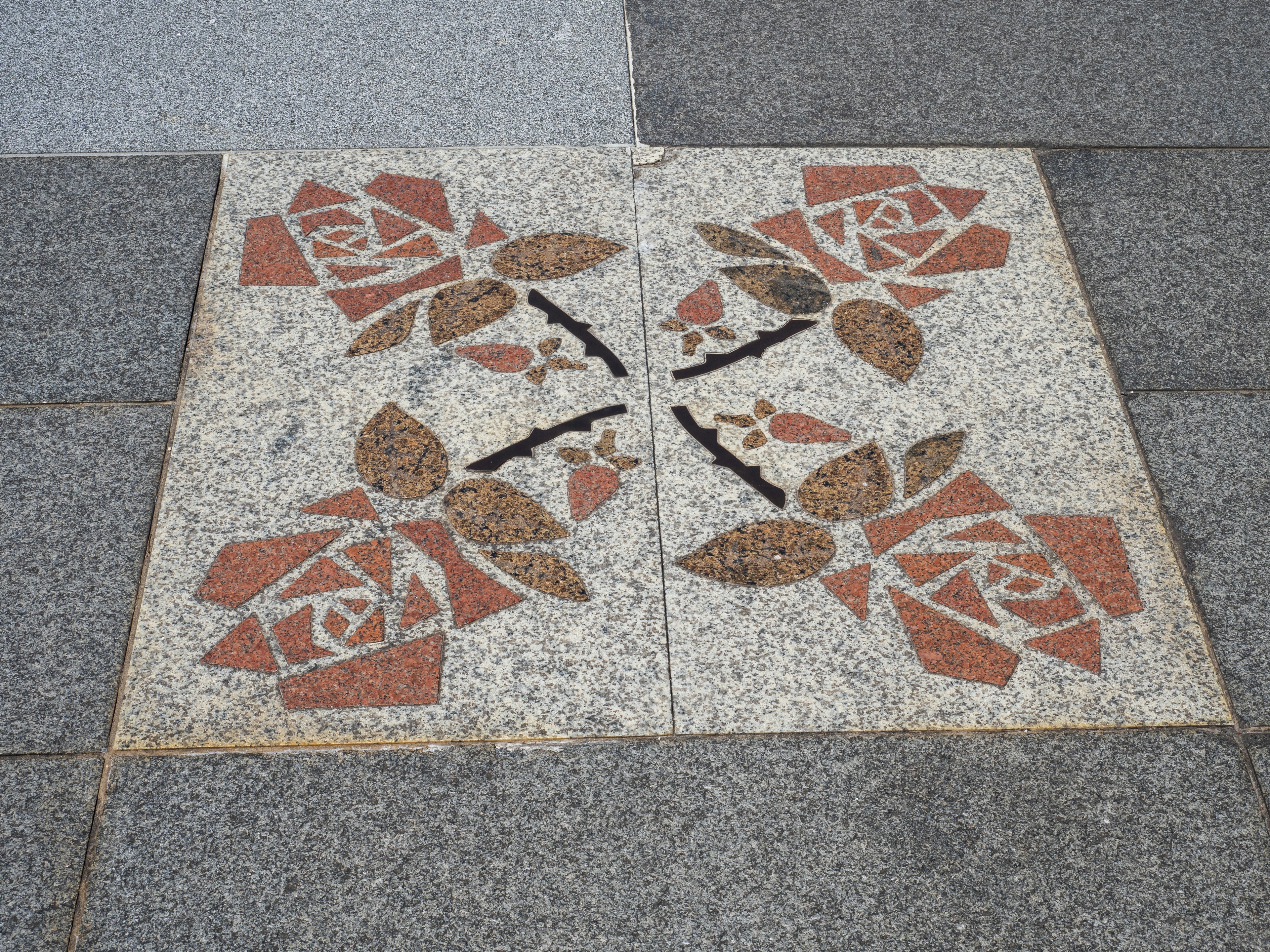 Mosaic tile featuring a design of red roses