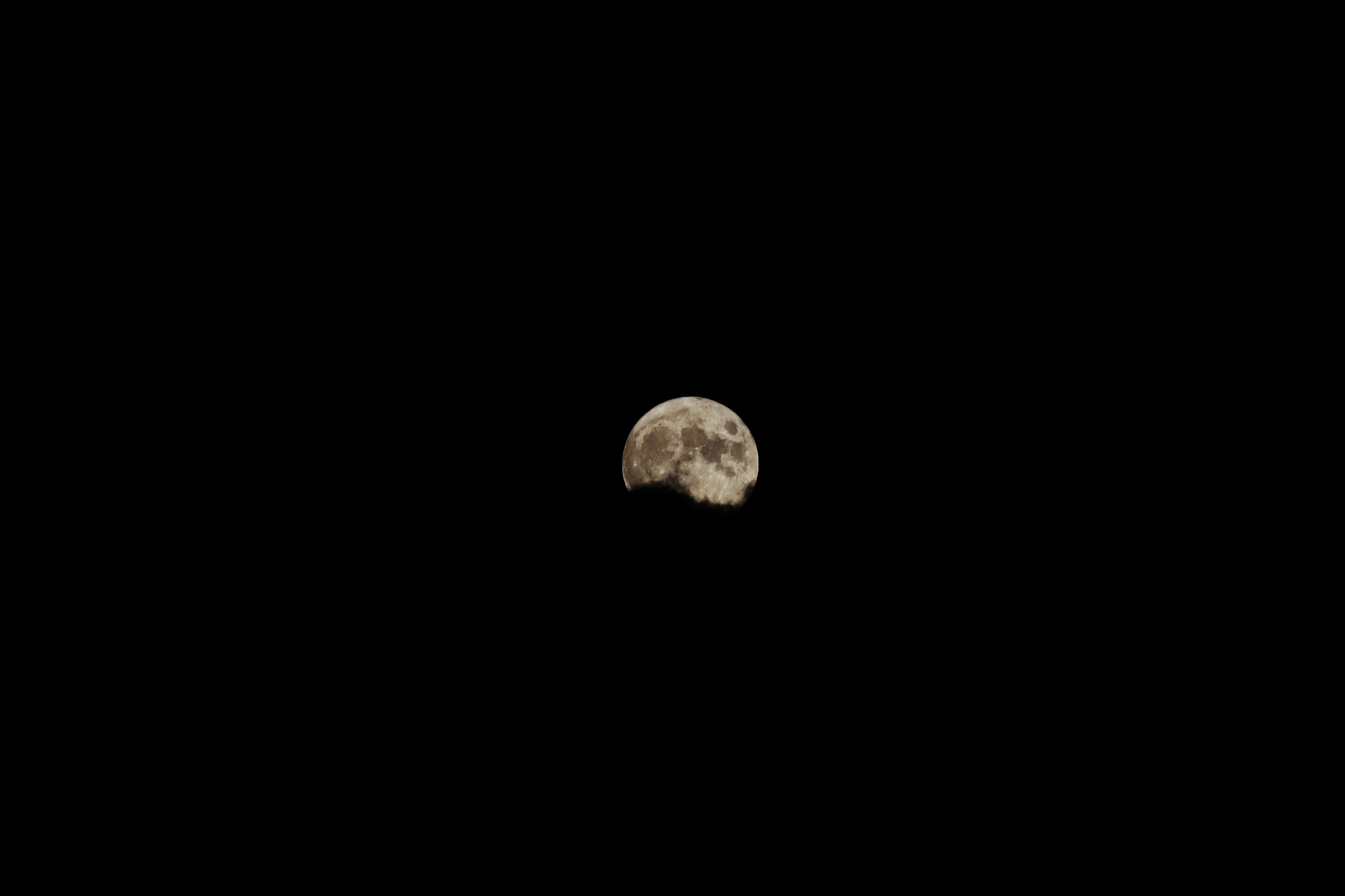 Small moon crater against a black background