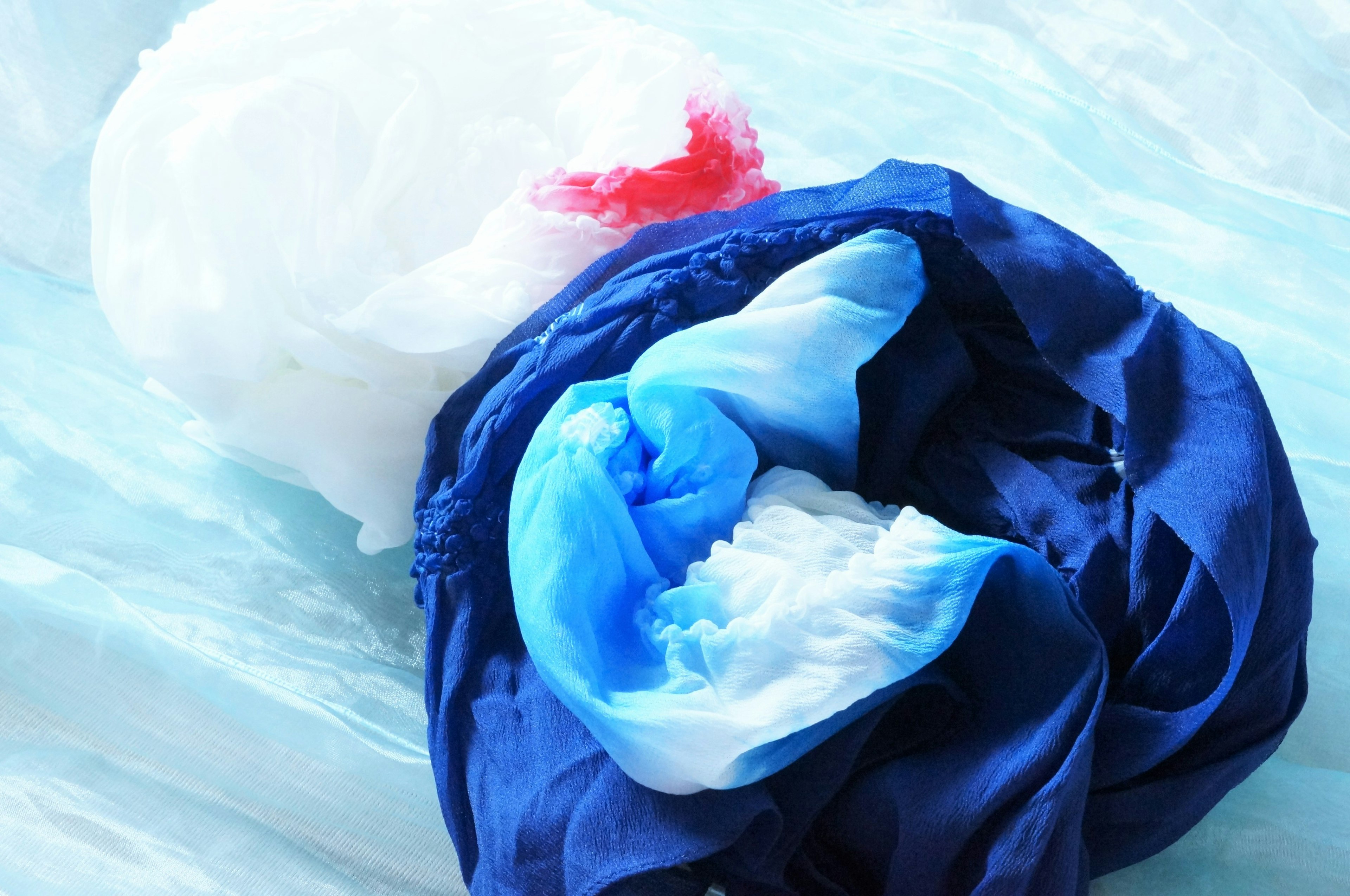 Image of intertwined blue and white fabric with soft textures