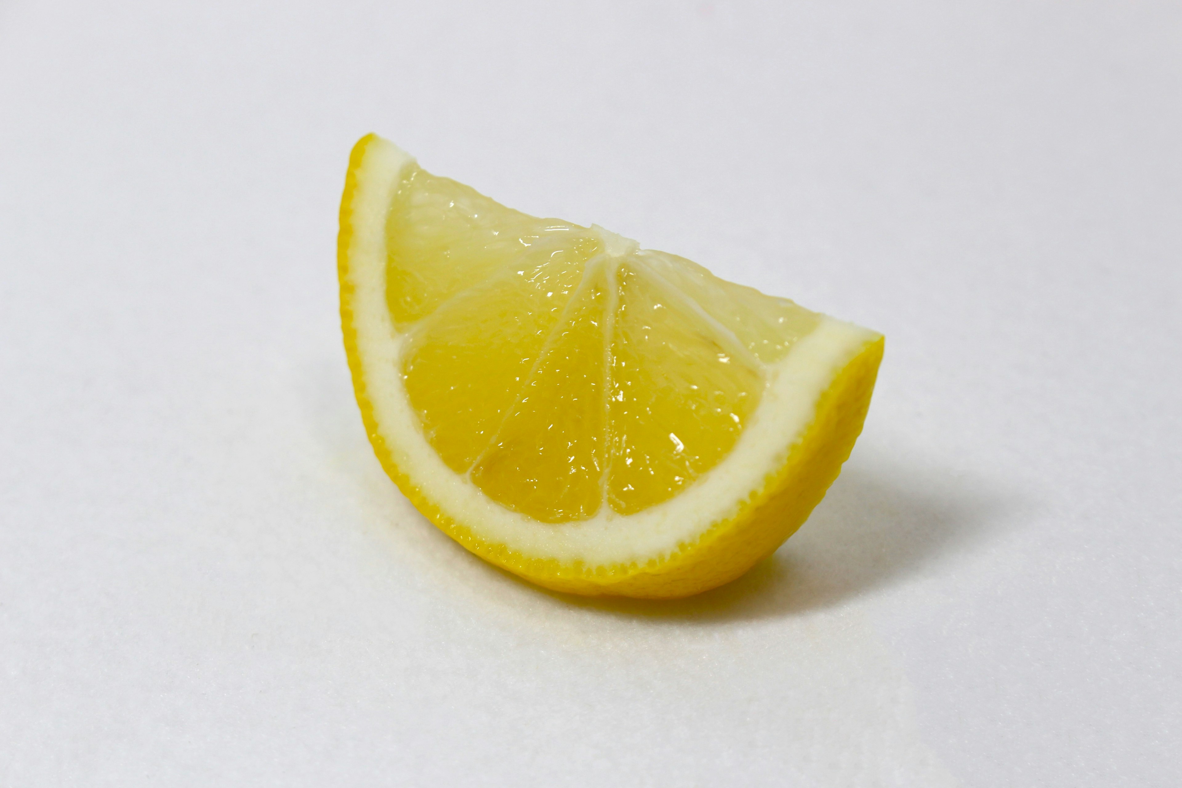 A fresh lemon slice on a white background