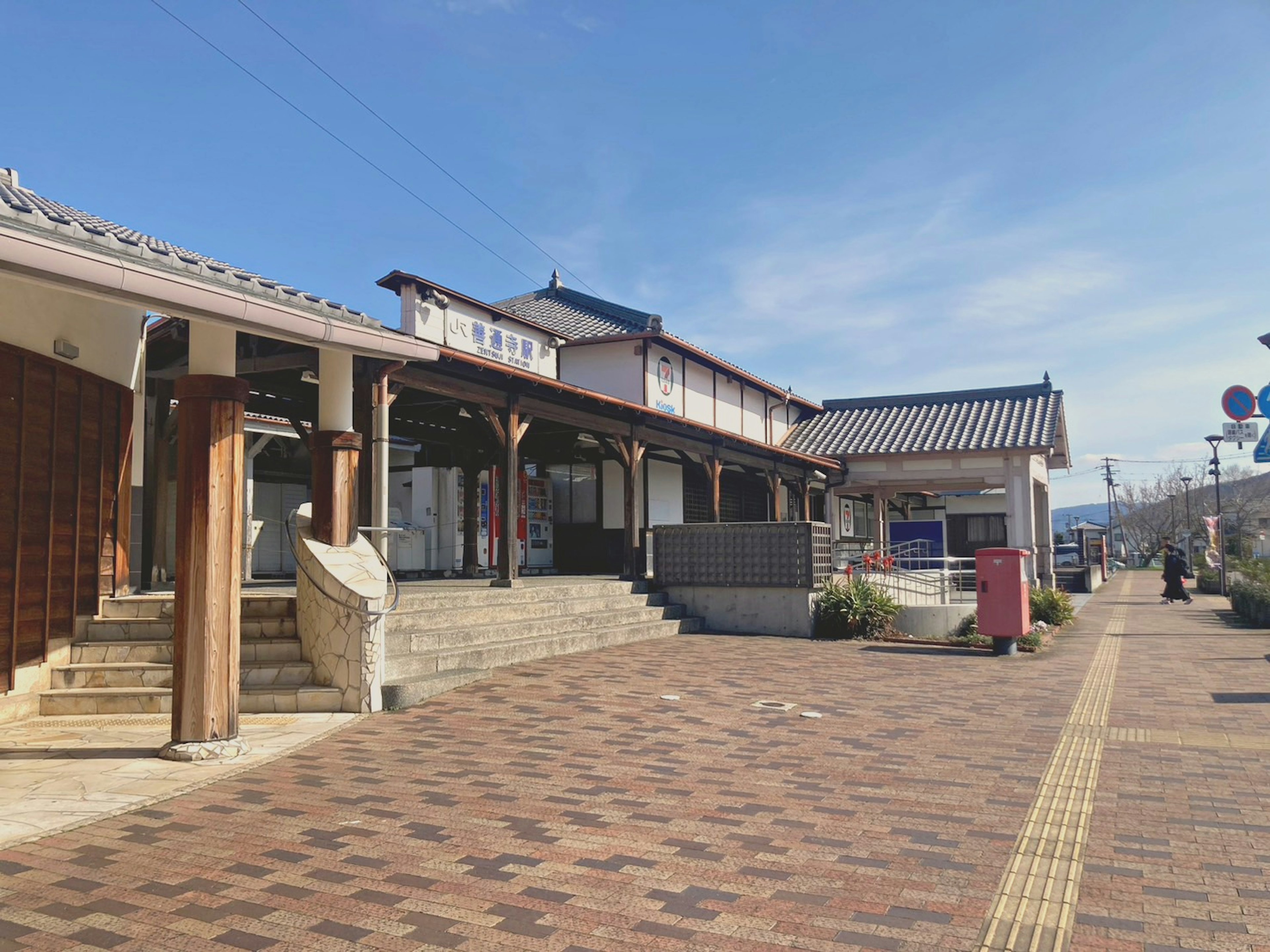 Scenic view of a train station with traditional architecture and paved walkway