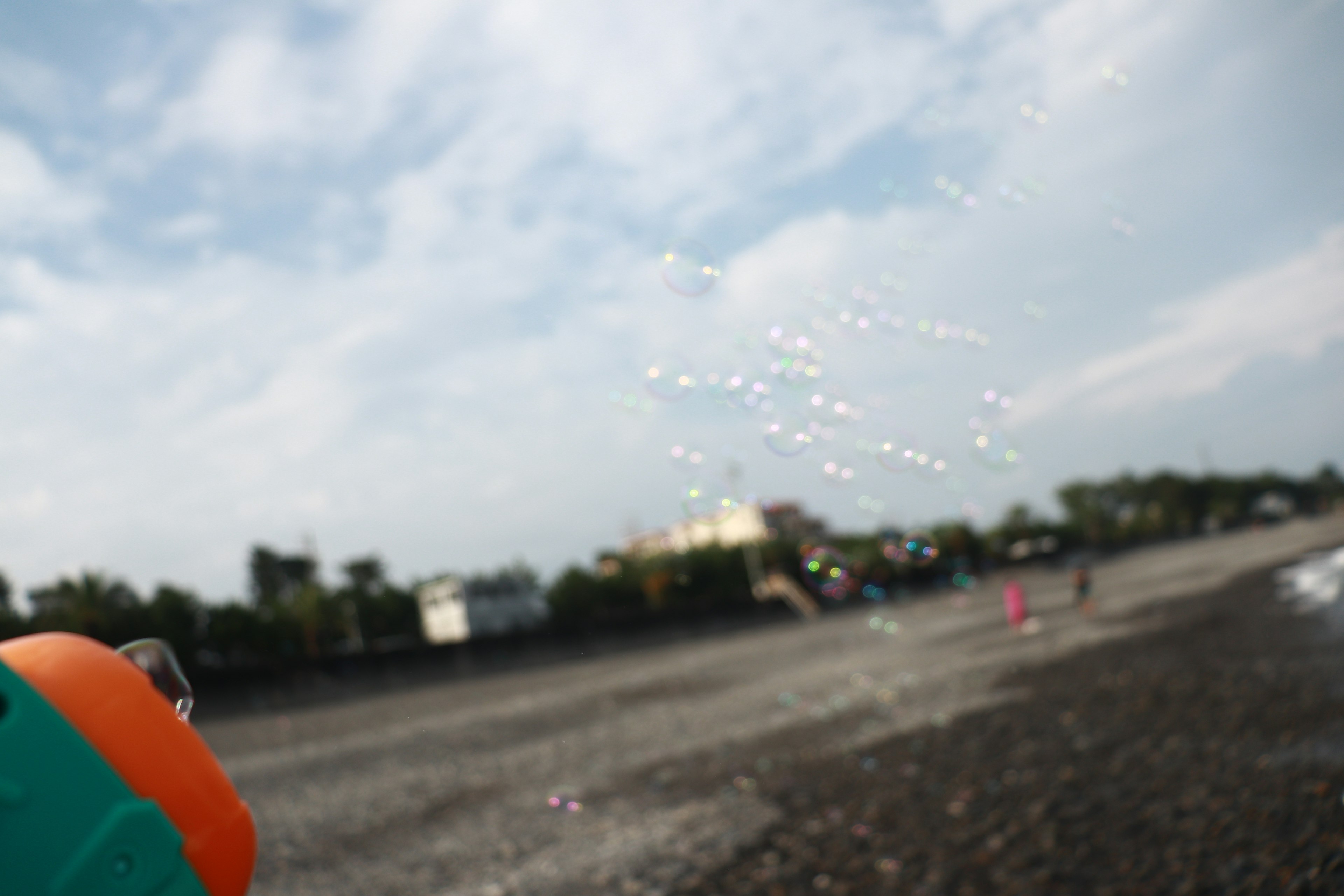 Water spraying toy with a cloudy blue sky in the background