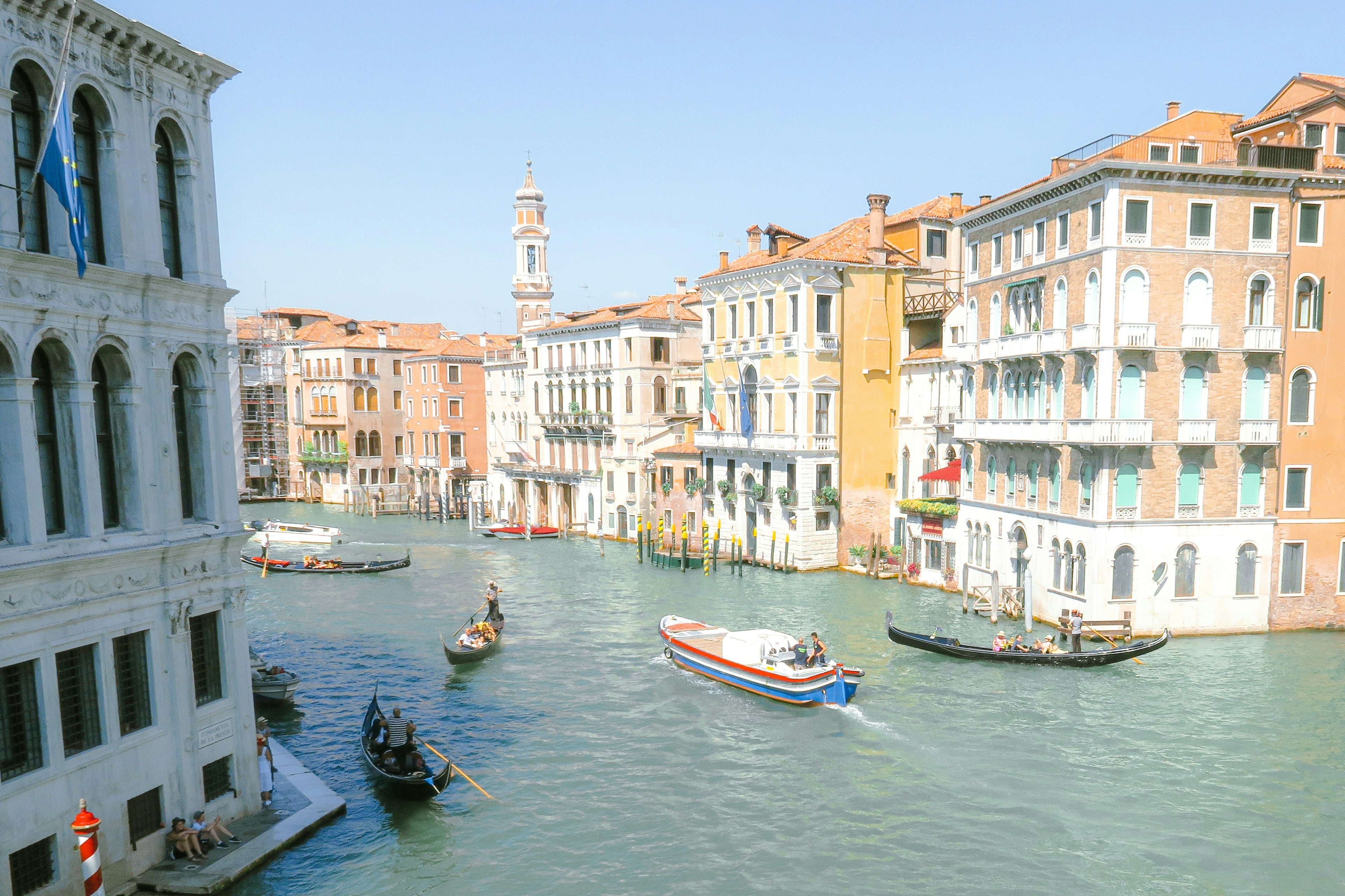 Boats on the canal in Venice with colorful buildings