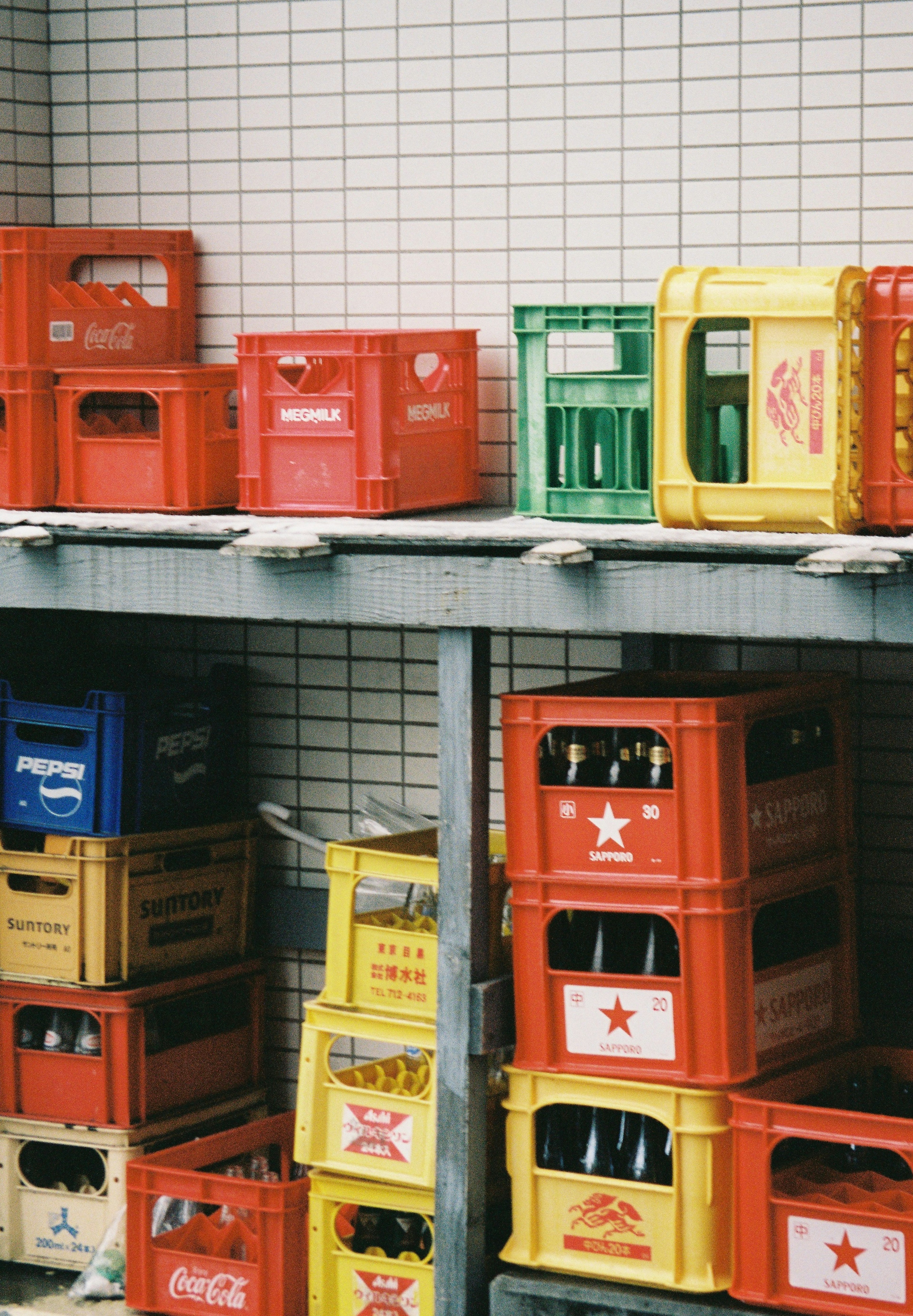 Colorful beverage crates stacked on shelves