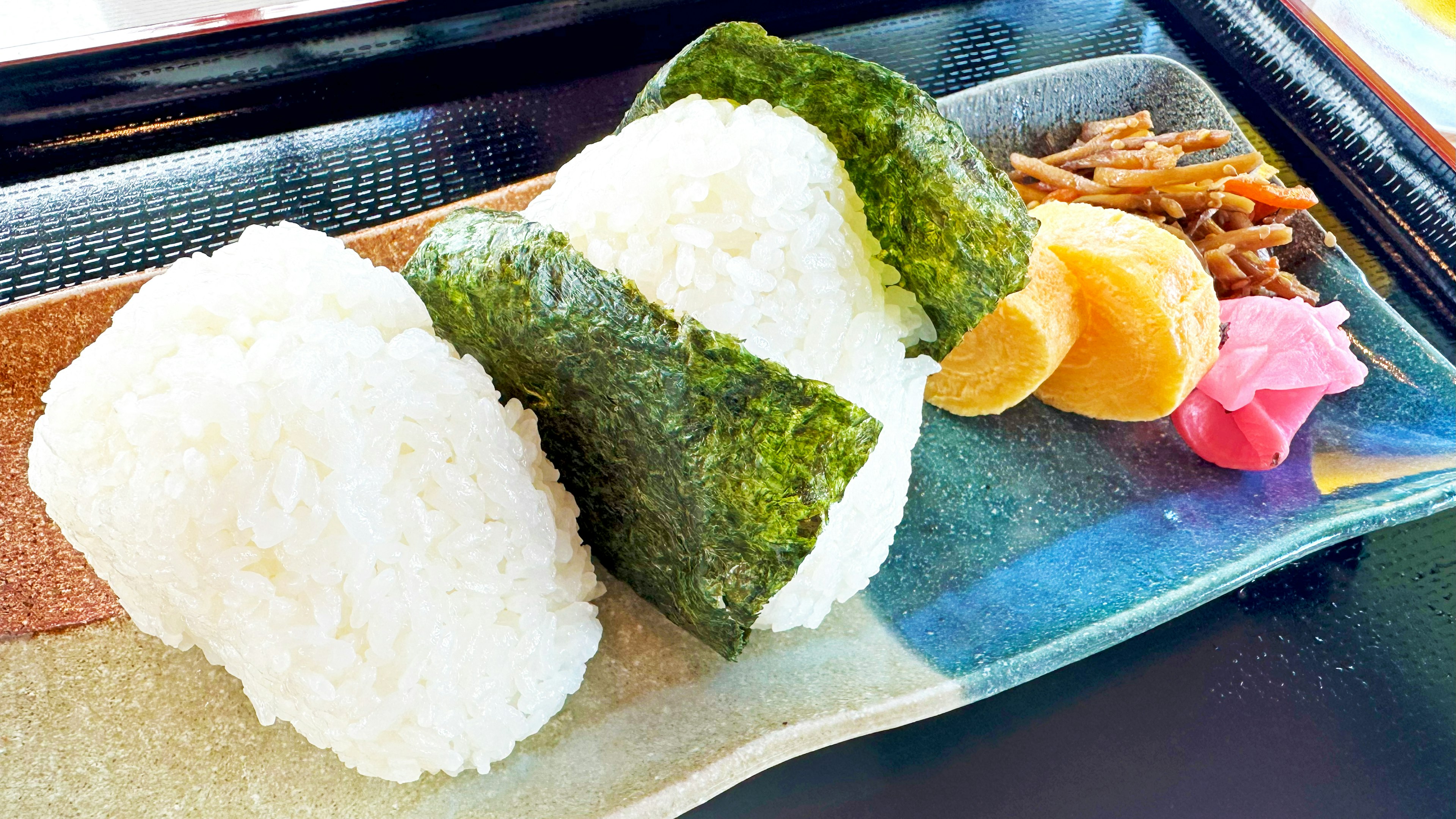 Bolas de arroz con nori y guarniciones variadas