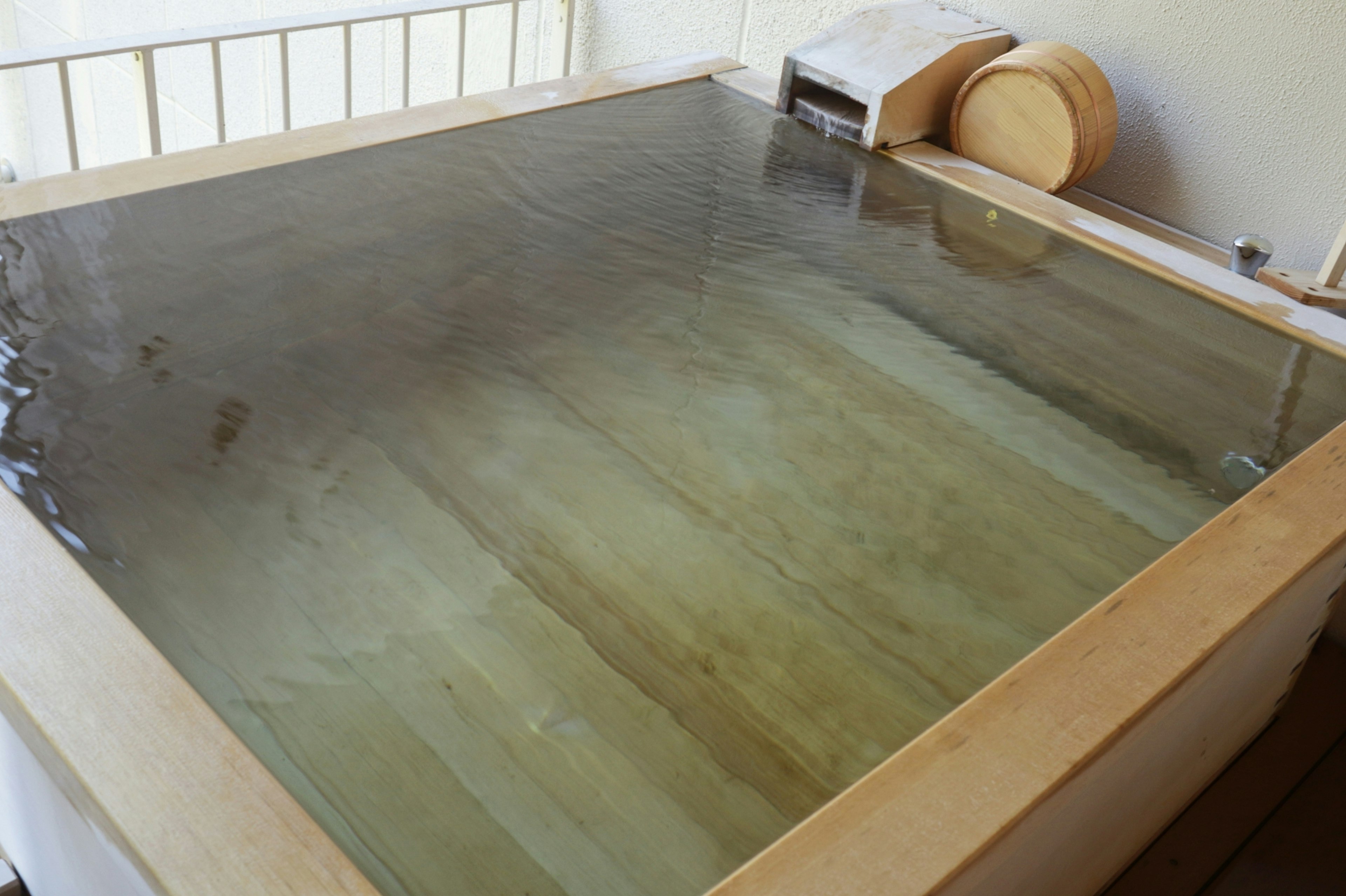 Baño termal de madera lleno de agua