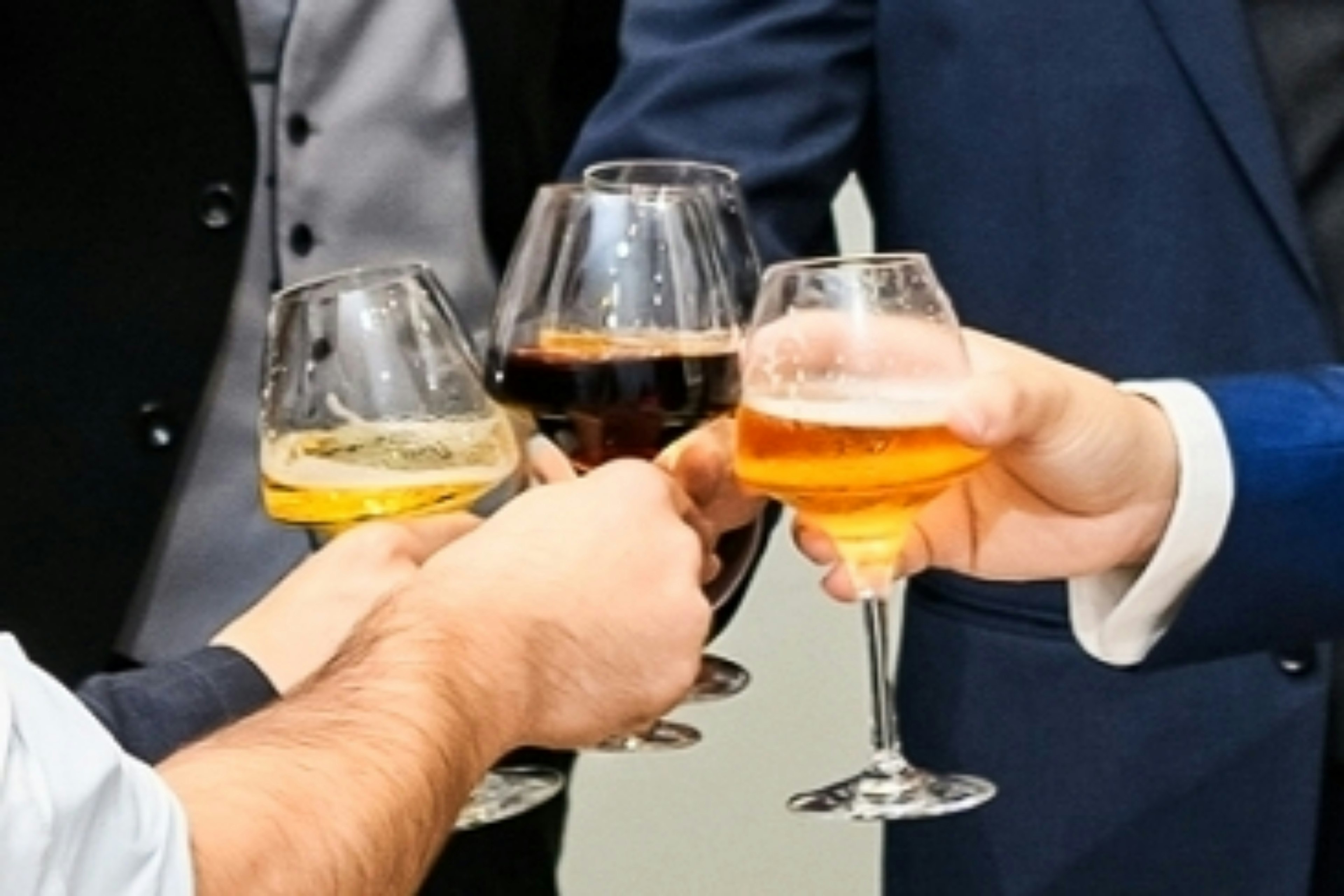 Hands of people toasting with four different glasses