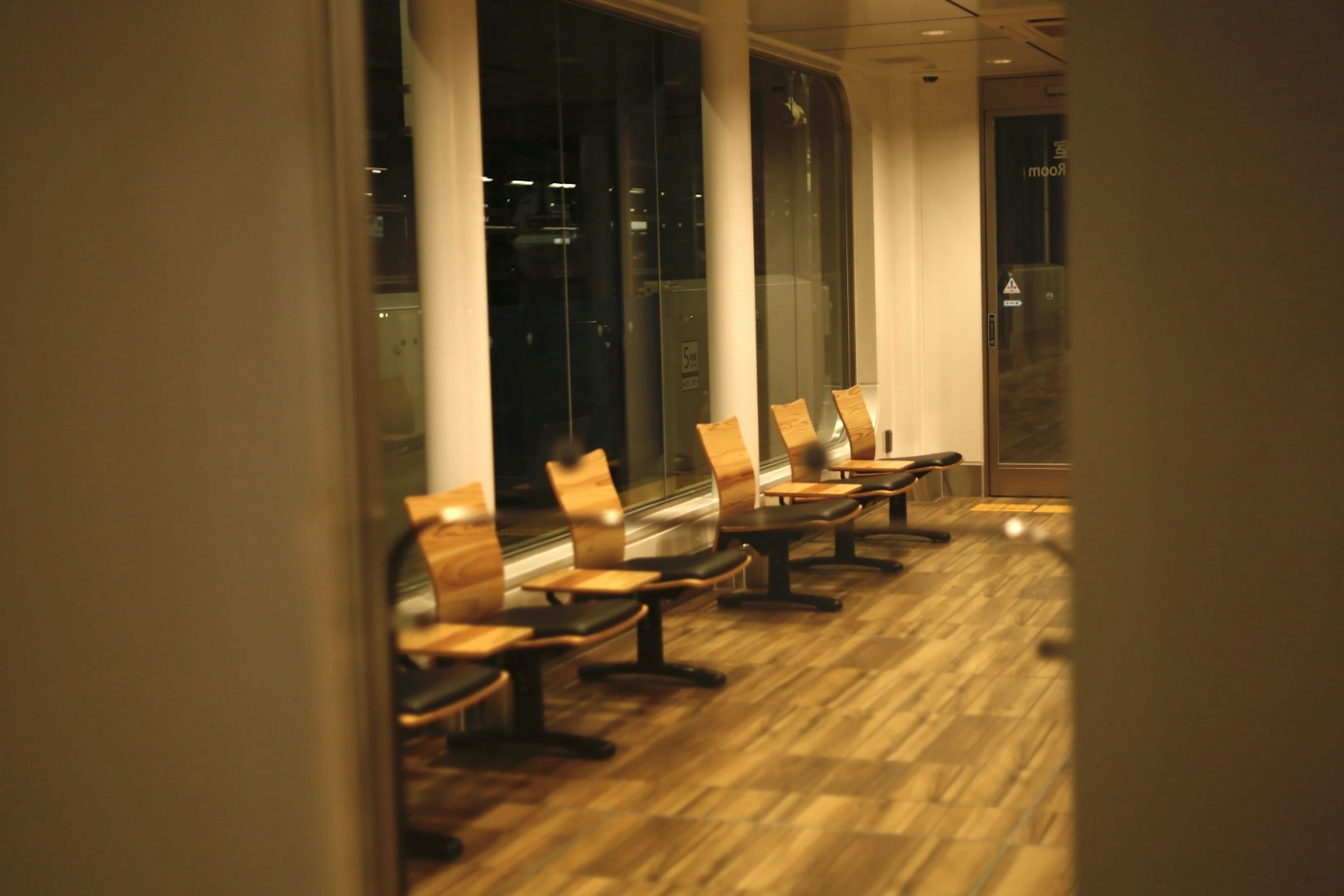 Quiet waiting area with wooden chairs and dim lighting