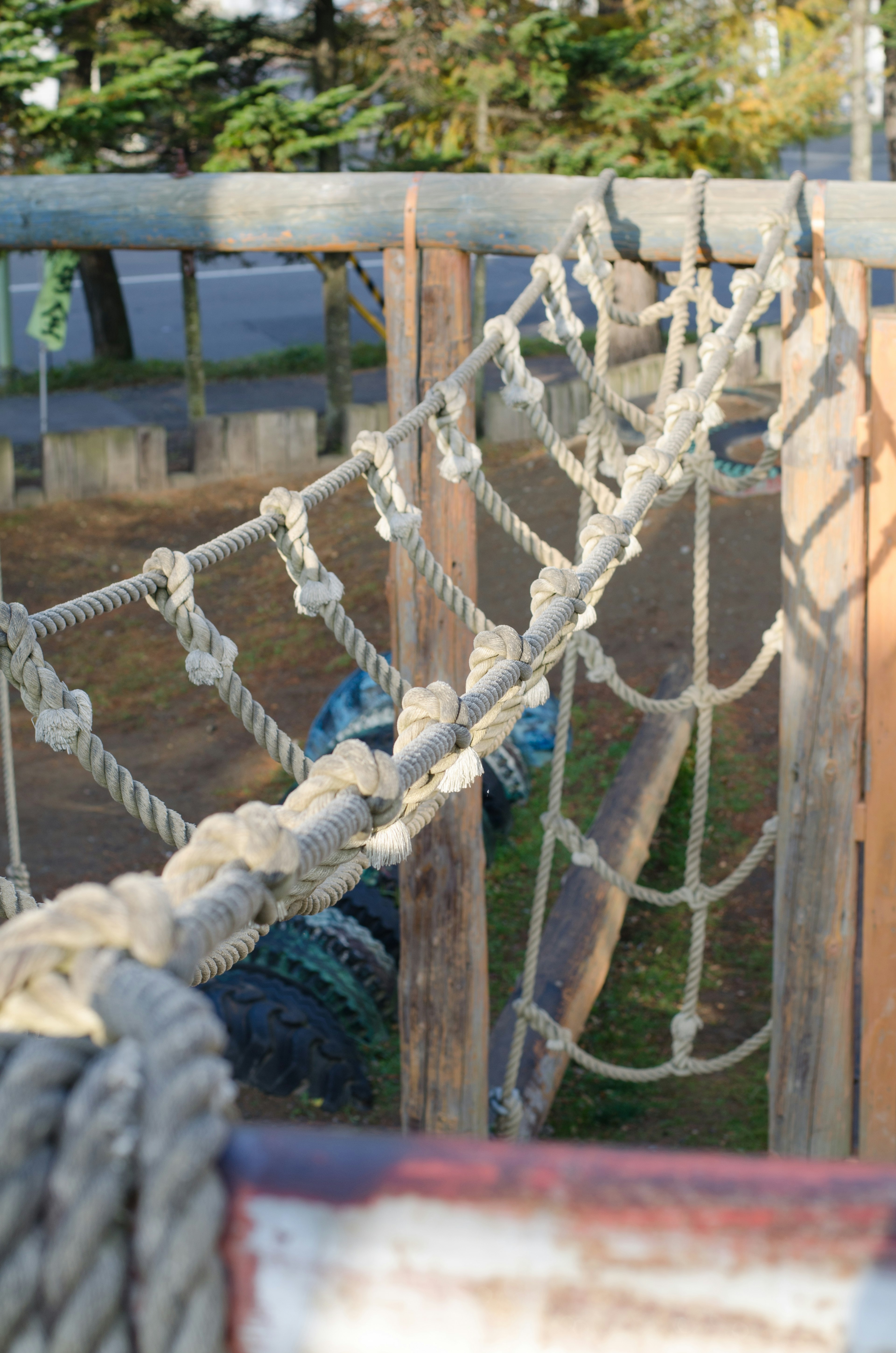 Close-up of a rope bridge in a playground with wooden supports