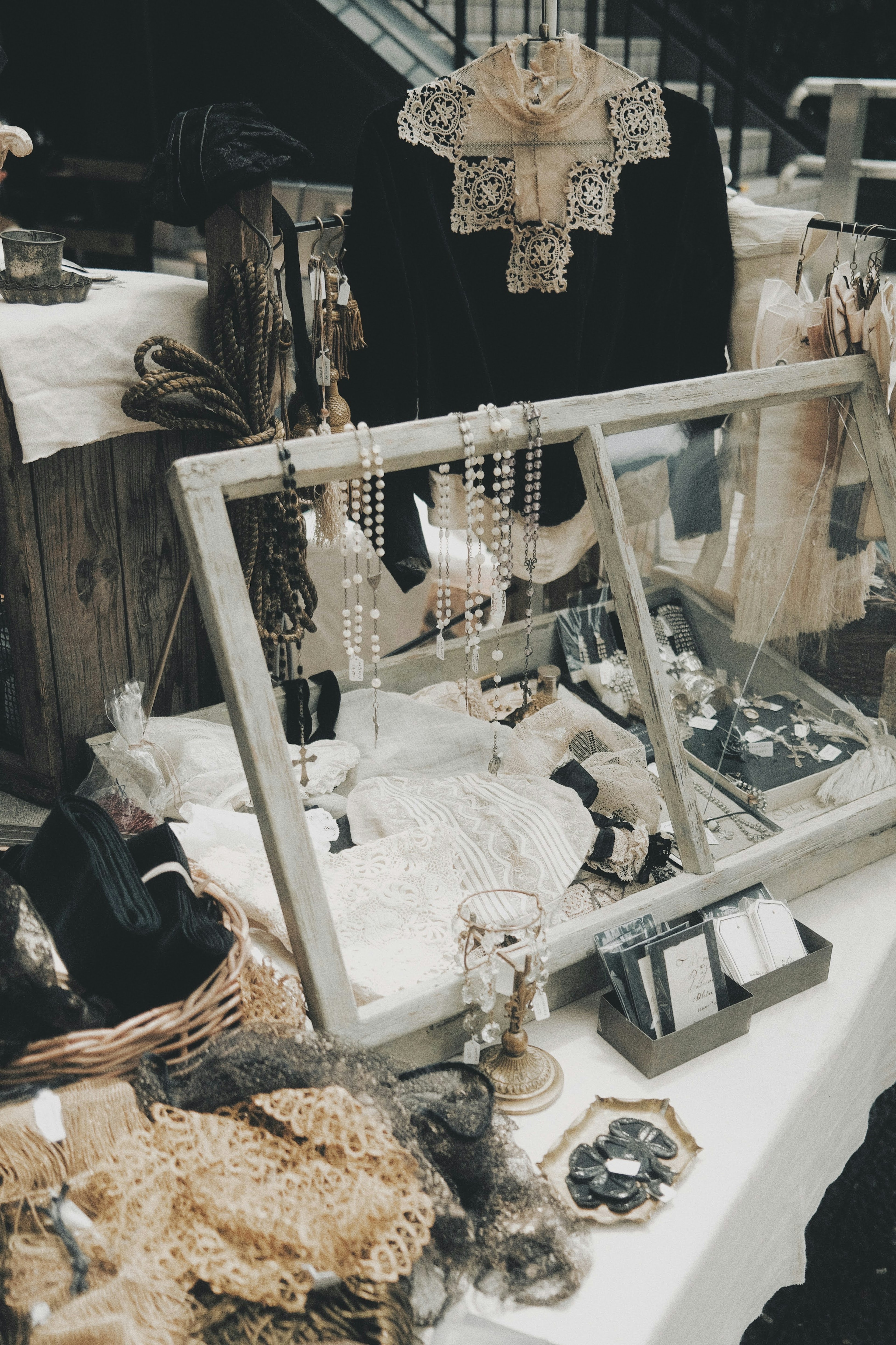 Vintage jewelry displayed on a market table