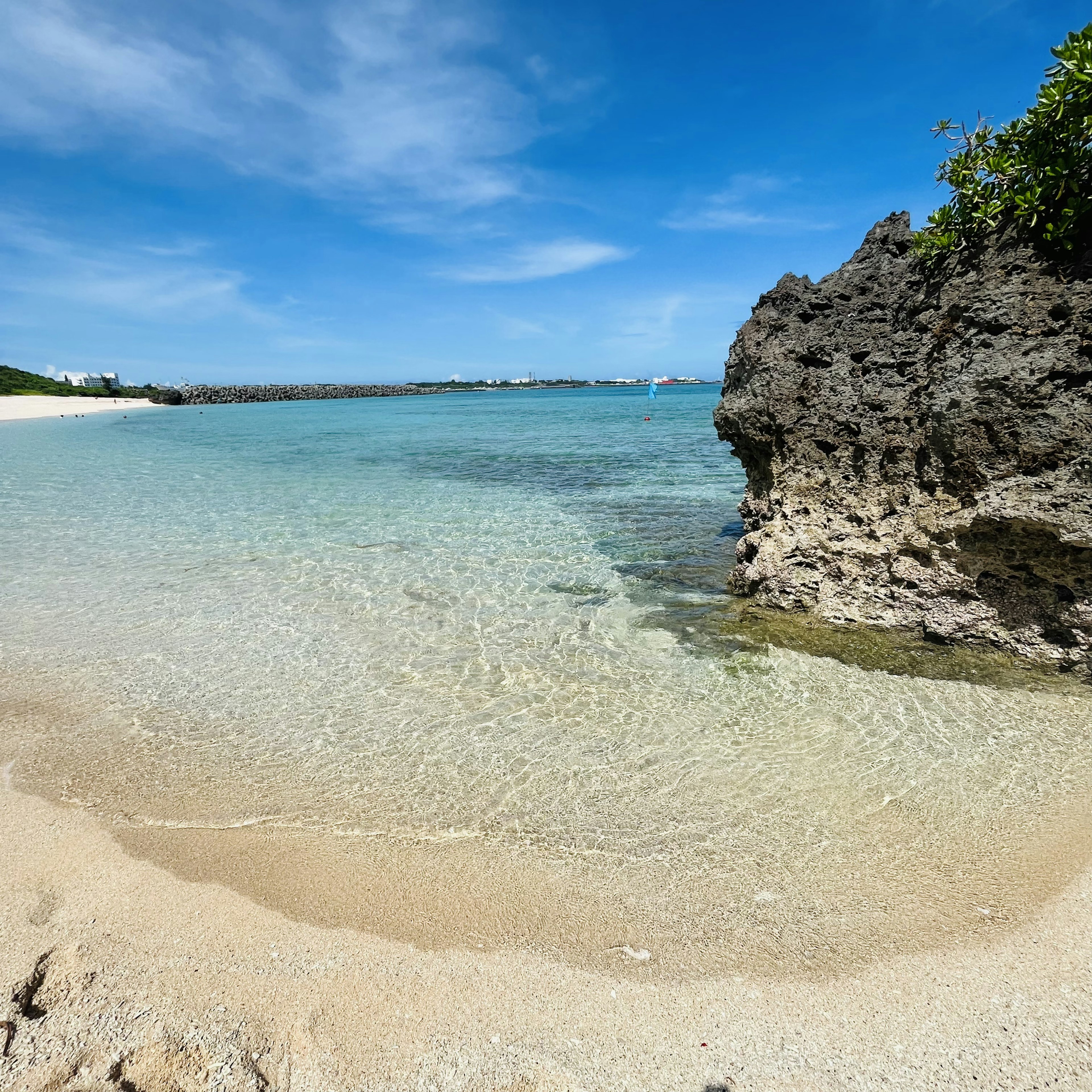 Beautiful beach scene with clear water and rocky shoreline