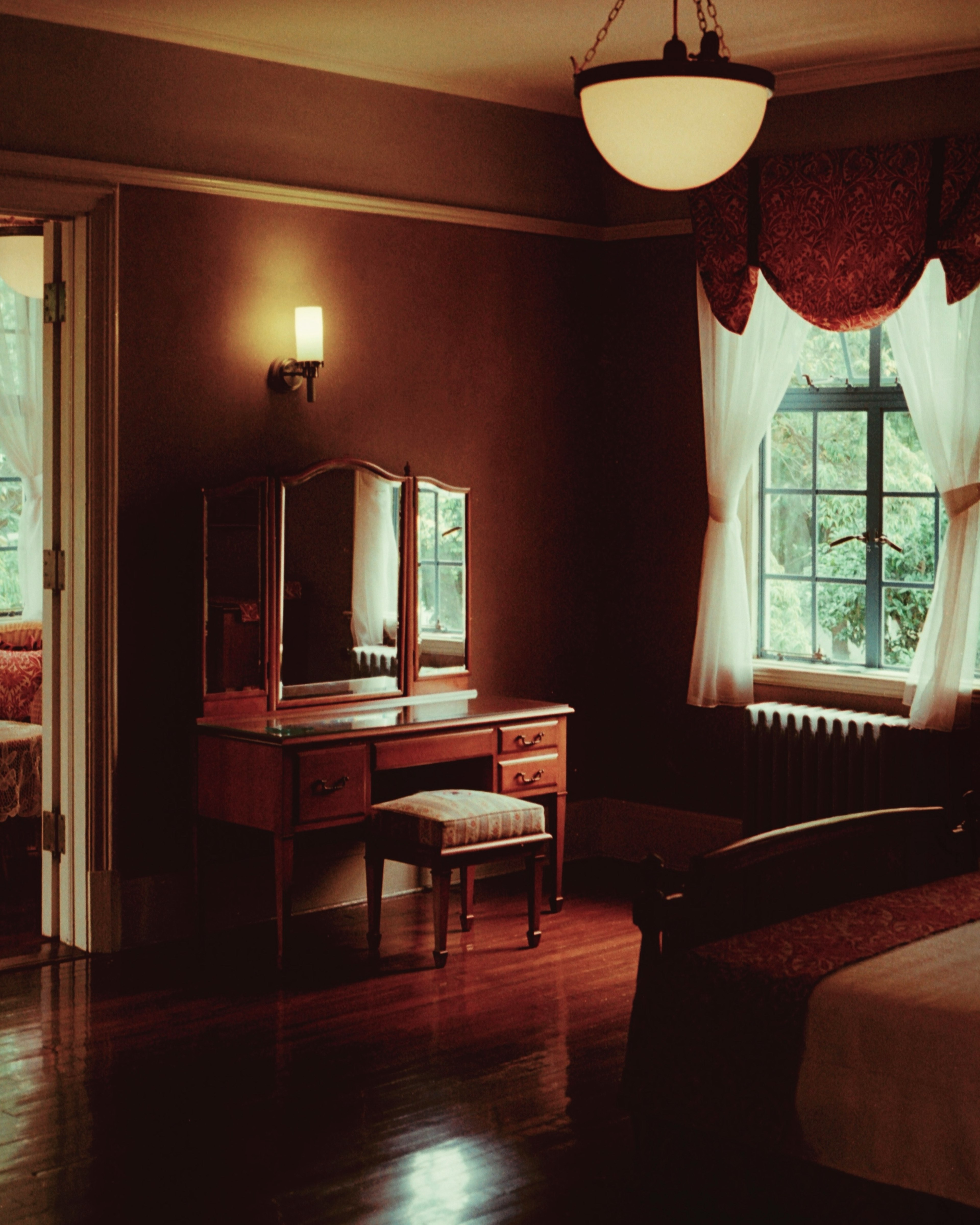 Cozy room featuring a wooden dresser and chair with natural light streaming through the window