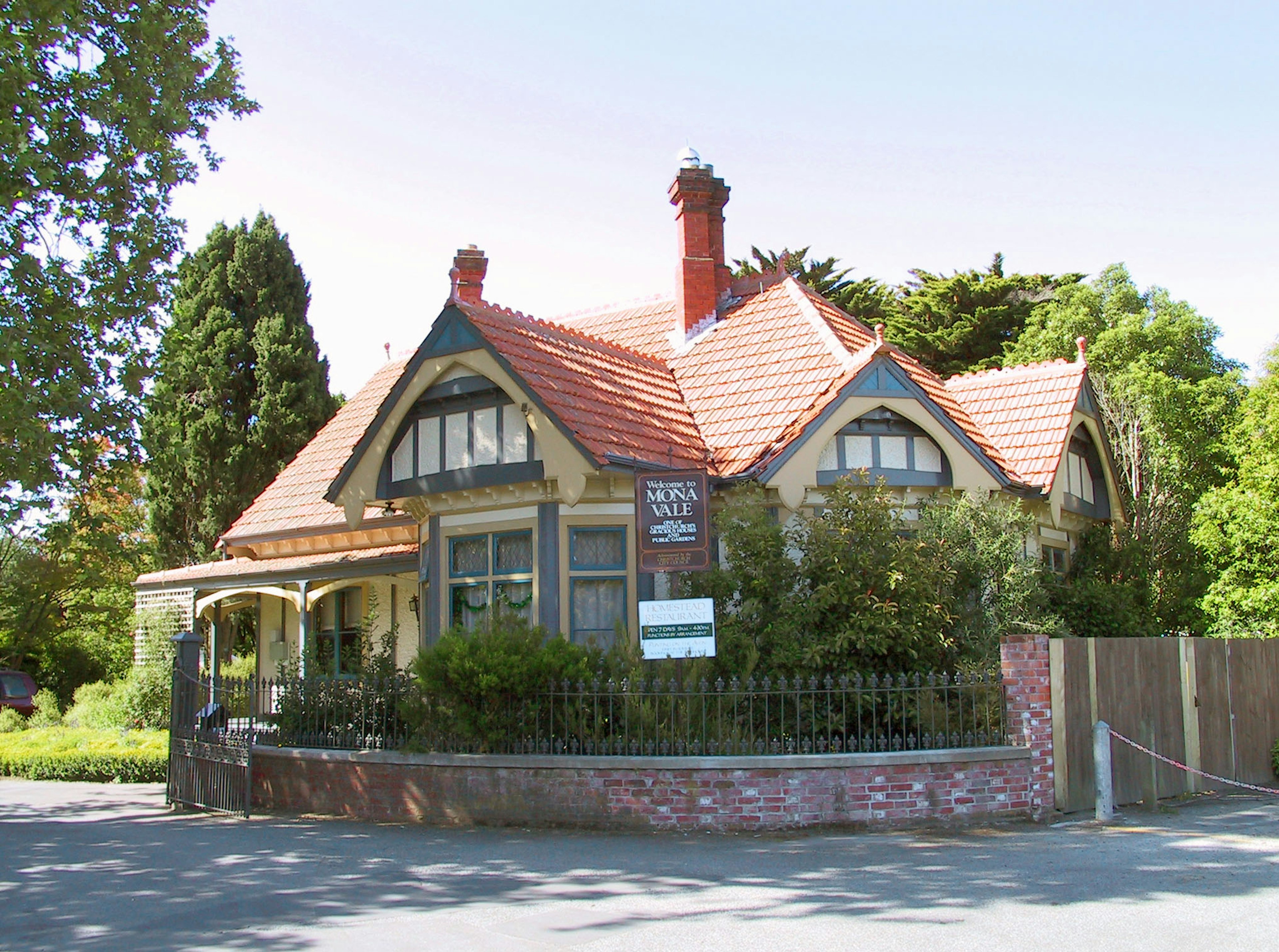 Charming old house with a red tiled roof and lush garden