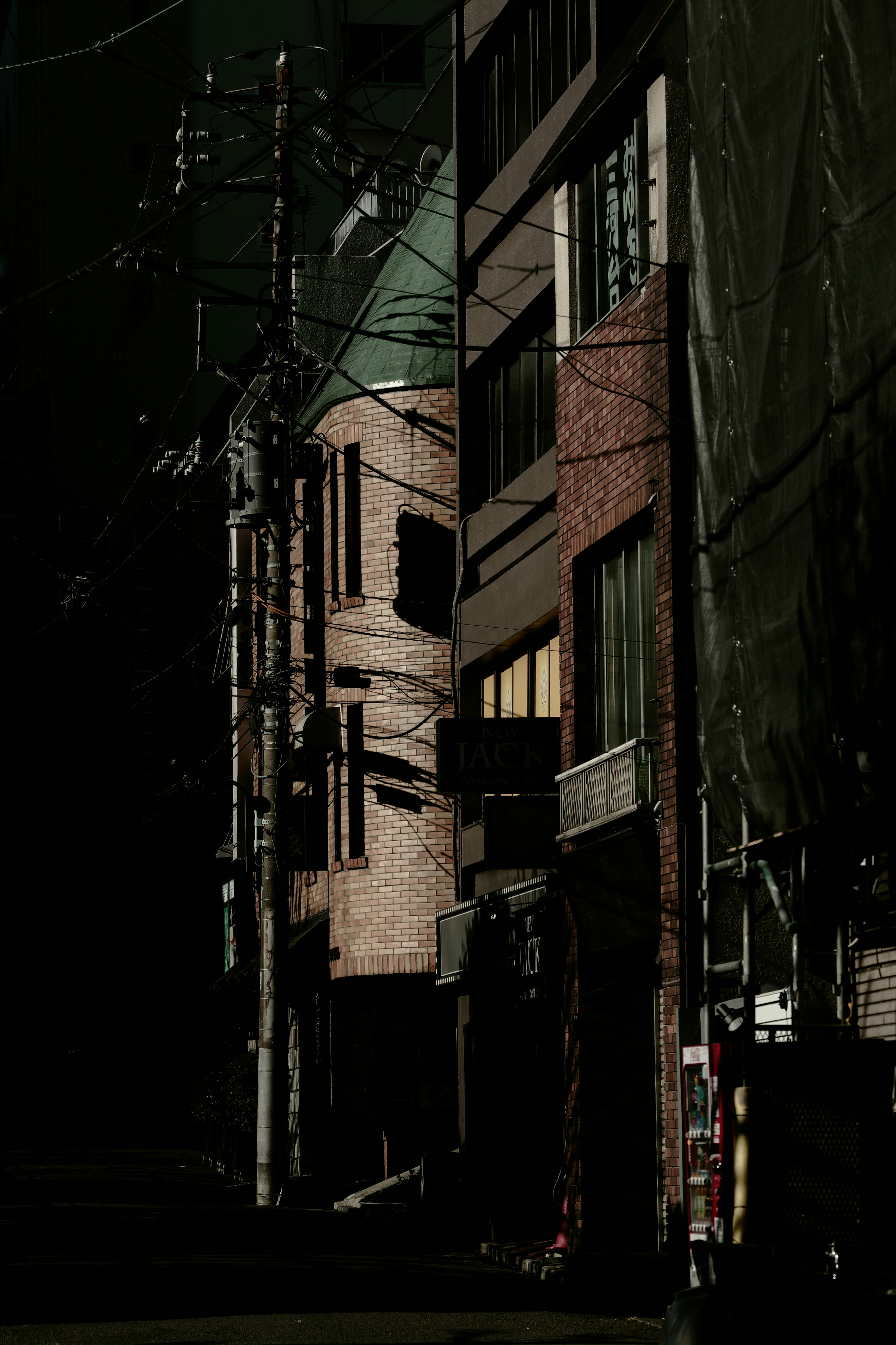 Dimly lit street with buildings and utility poles