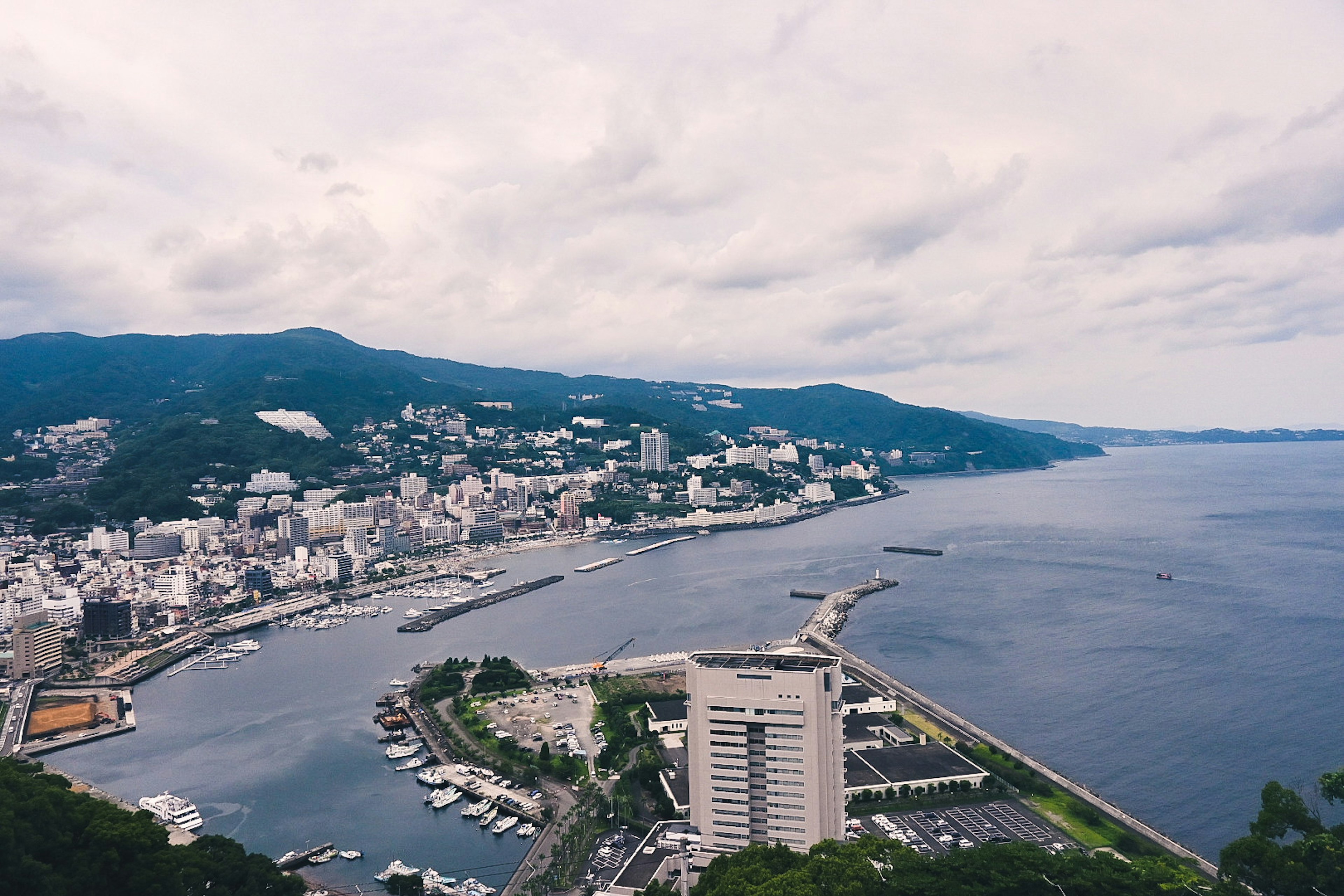 Panoramic view of a coastal city with cloudy sky