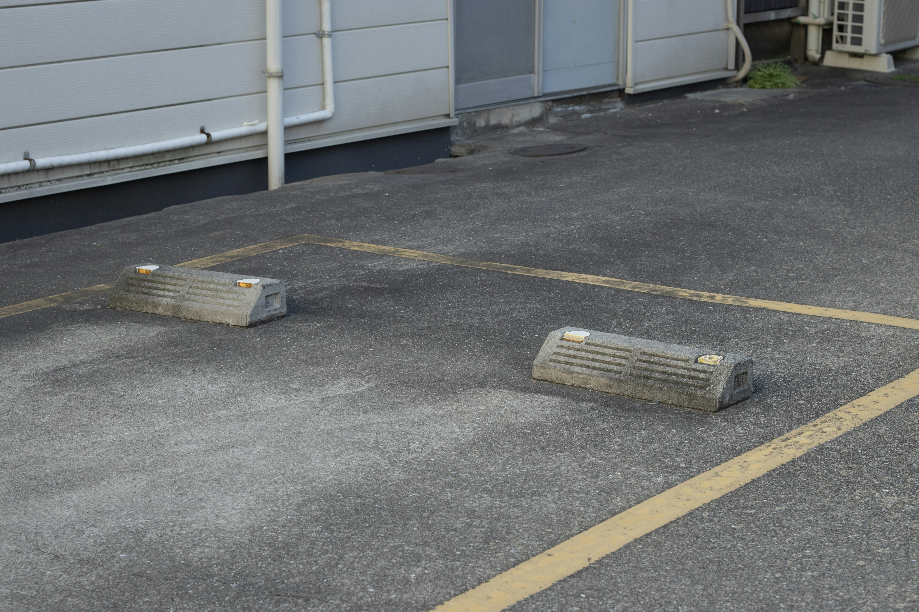 Two parking stops on a parking lot surface