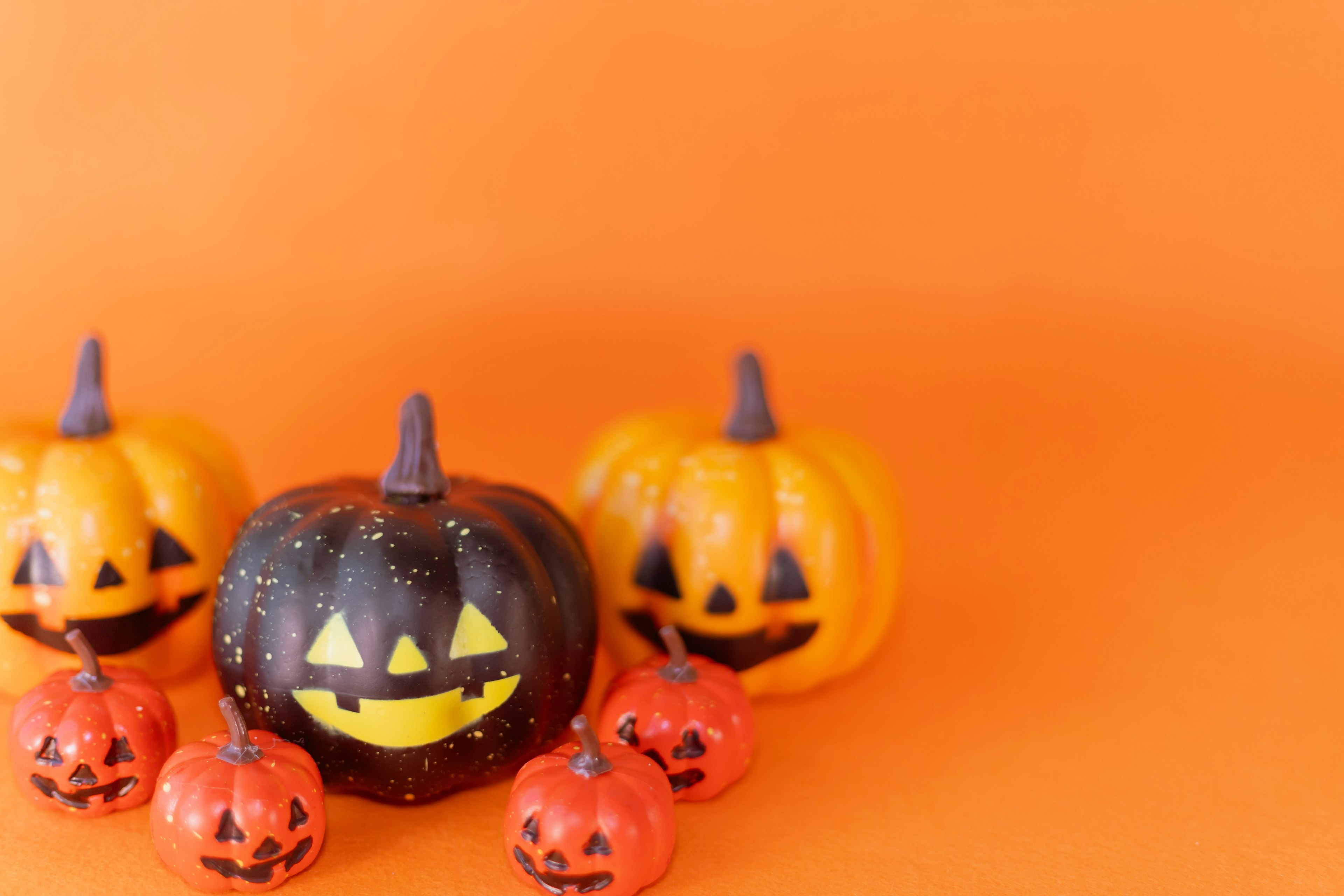 Halloween decorations featuring pumpkins in orange background