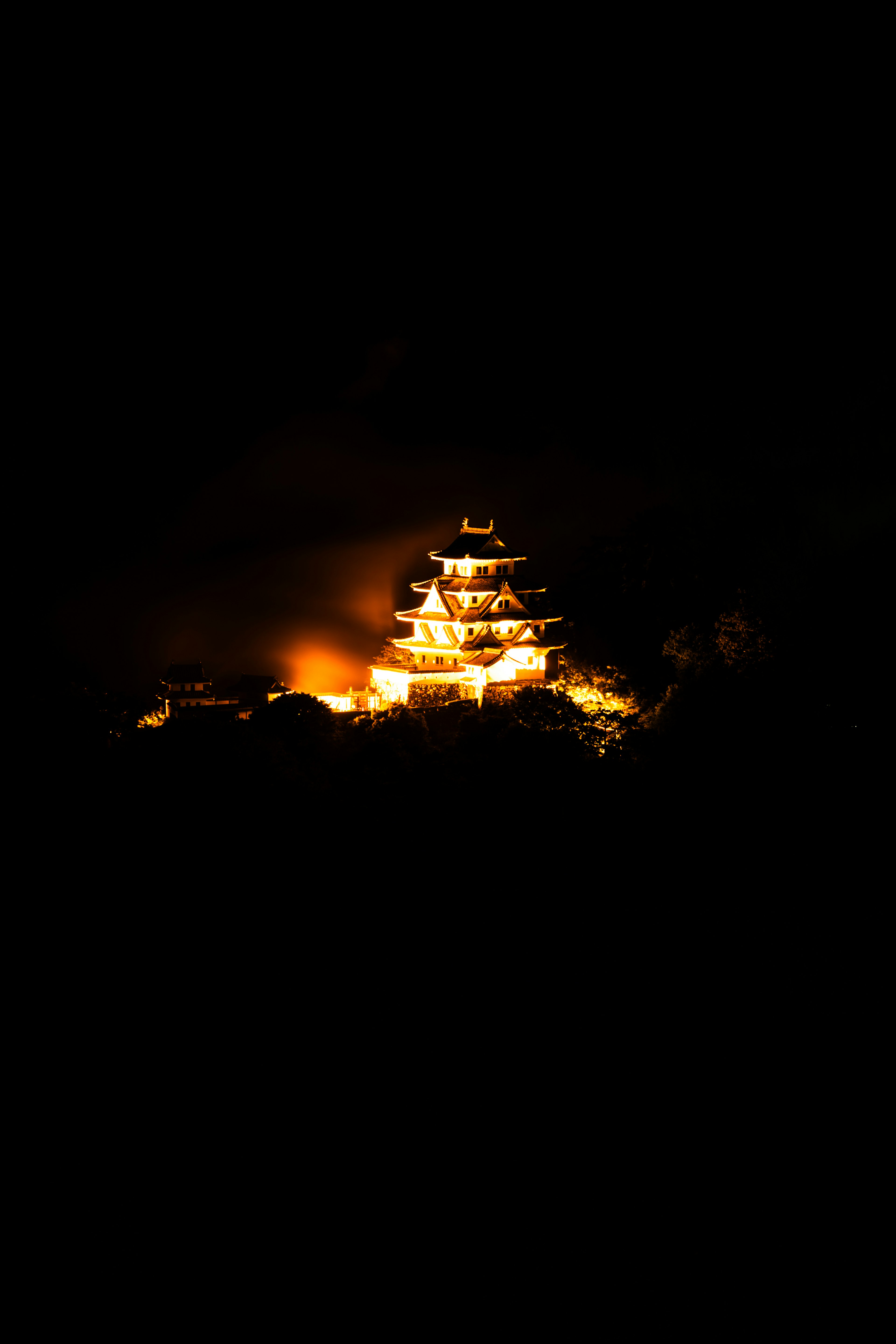 Illuminated castle at night with a serene atmosphere