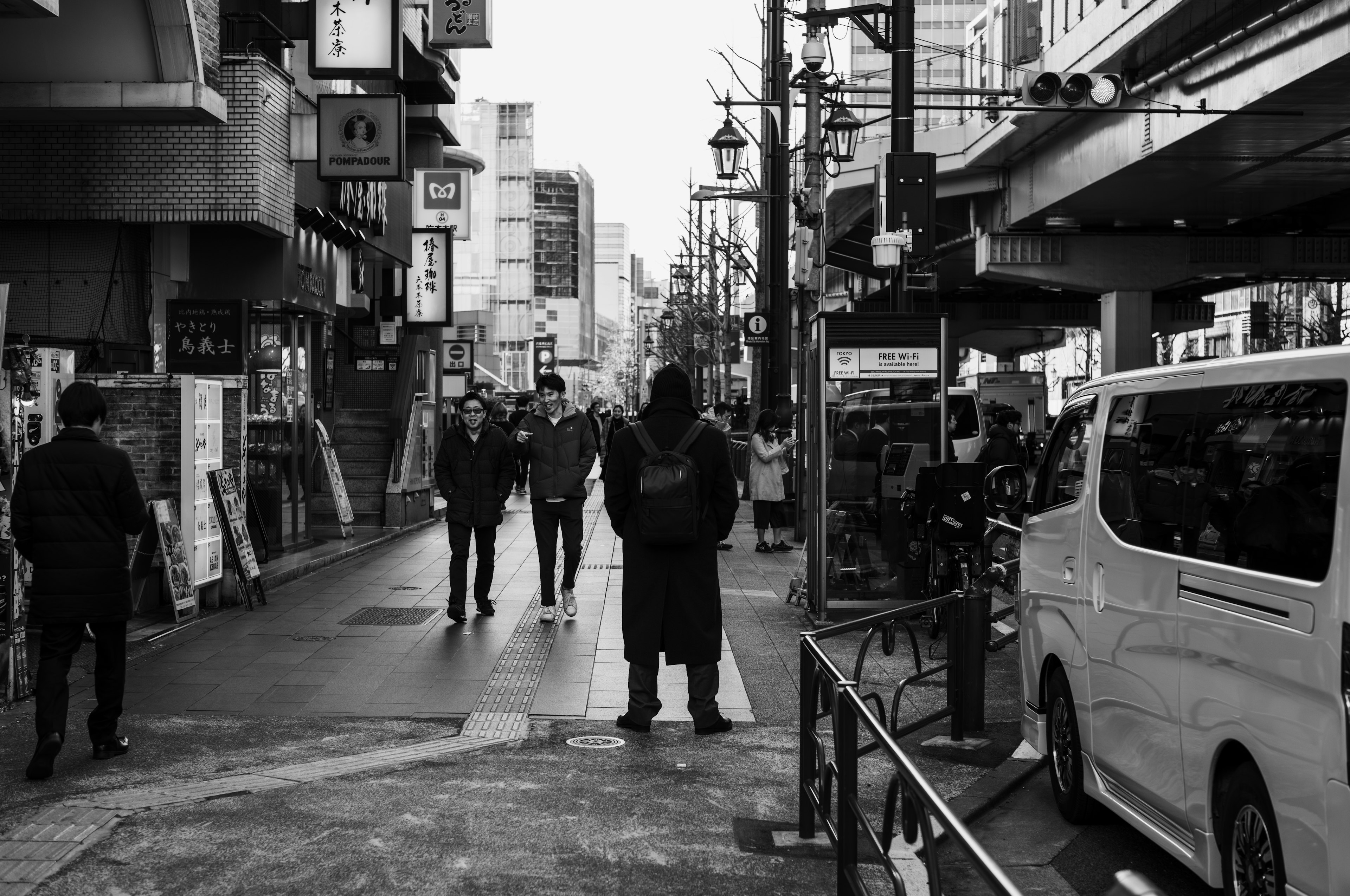 Black and white street scene with people walking