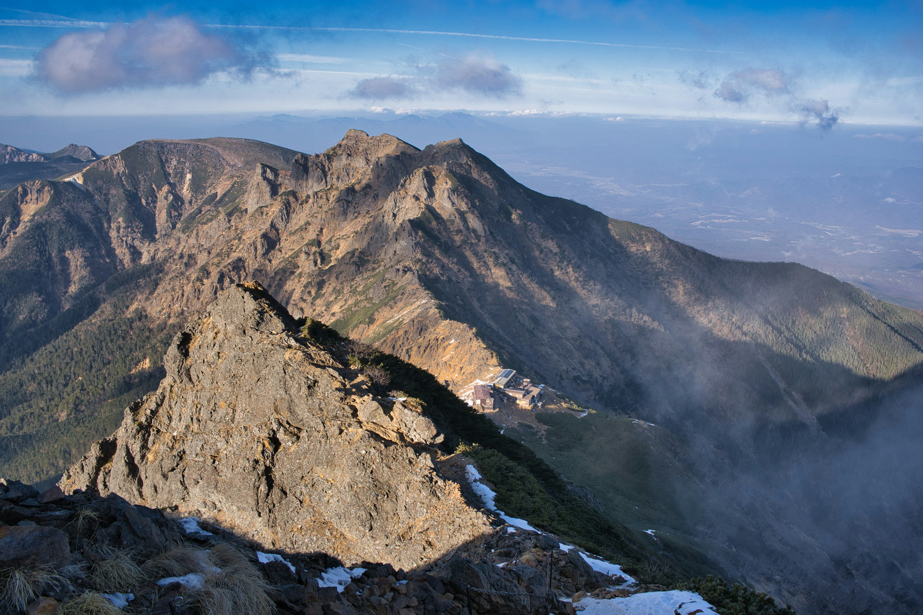 Stunning mountain view from the summit with clouds drifting