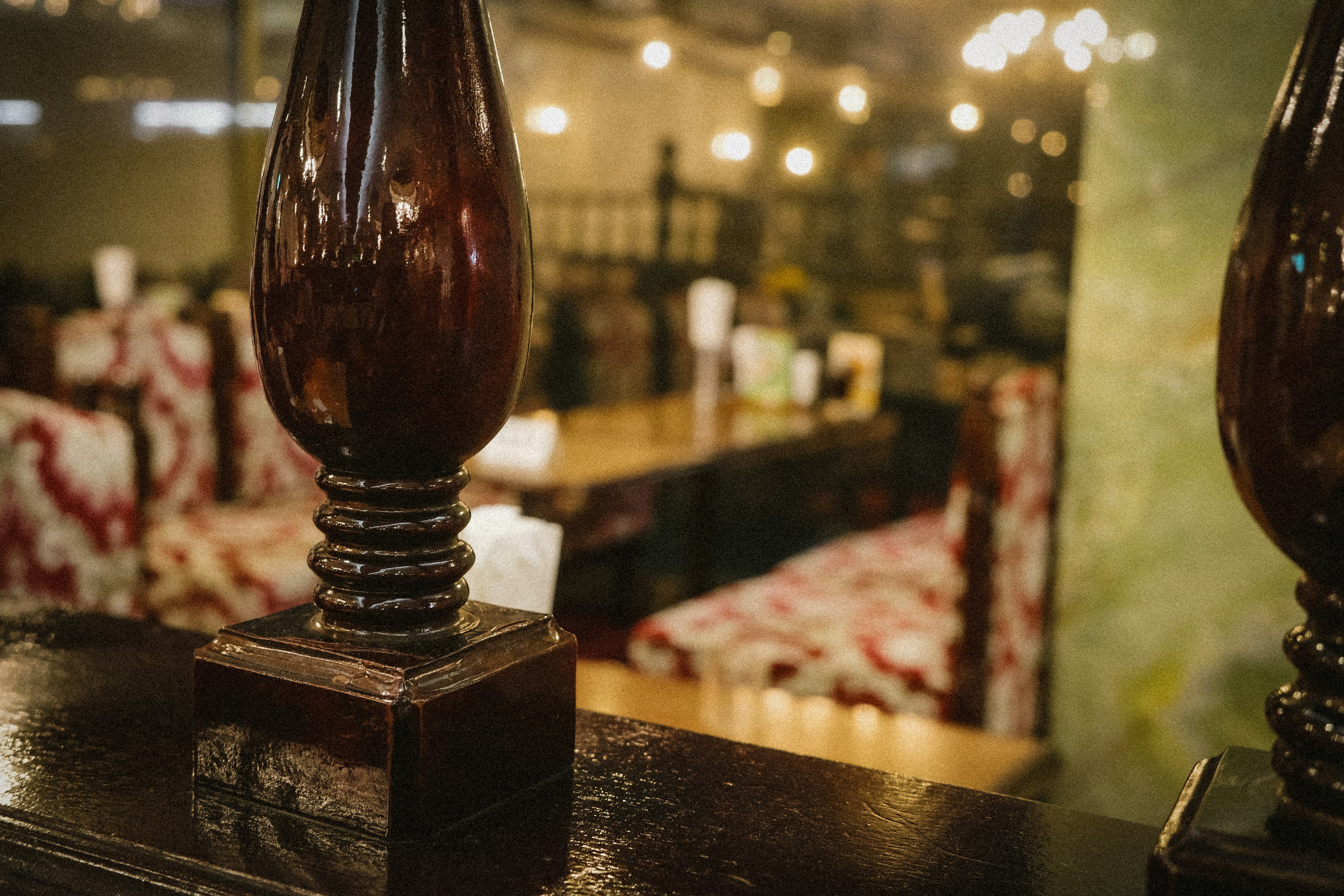 Decorative column in a restaurant interior with blurred tables