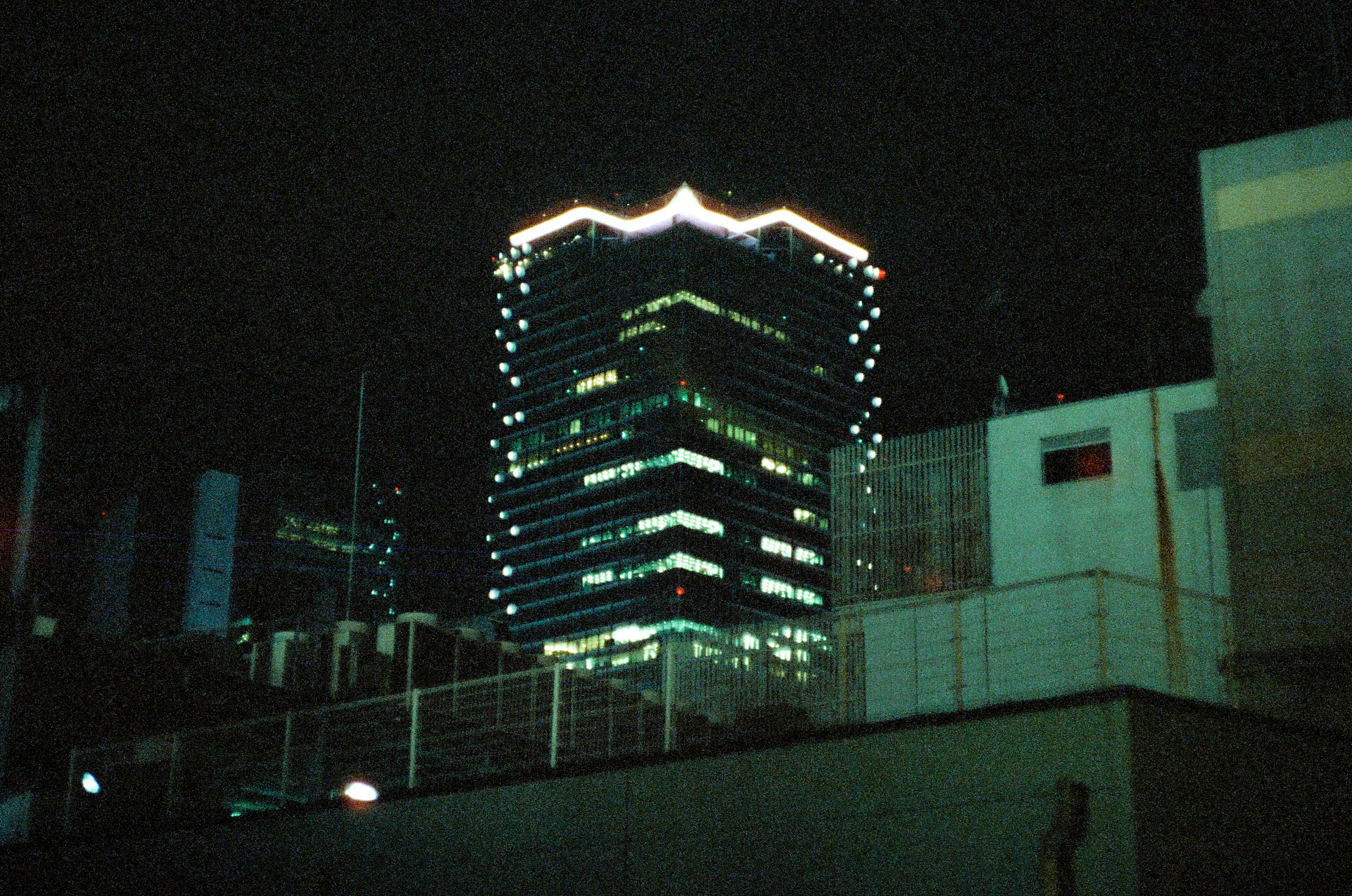 Illuminated skyscraper at night with decorative lights