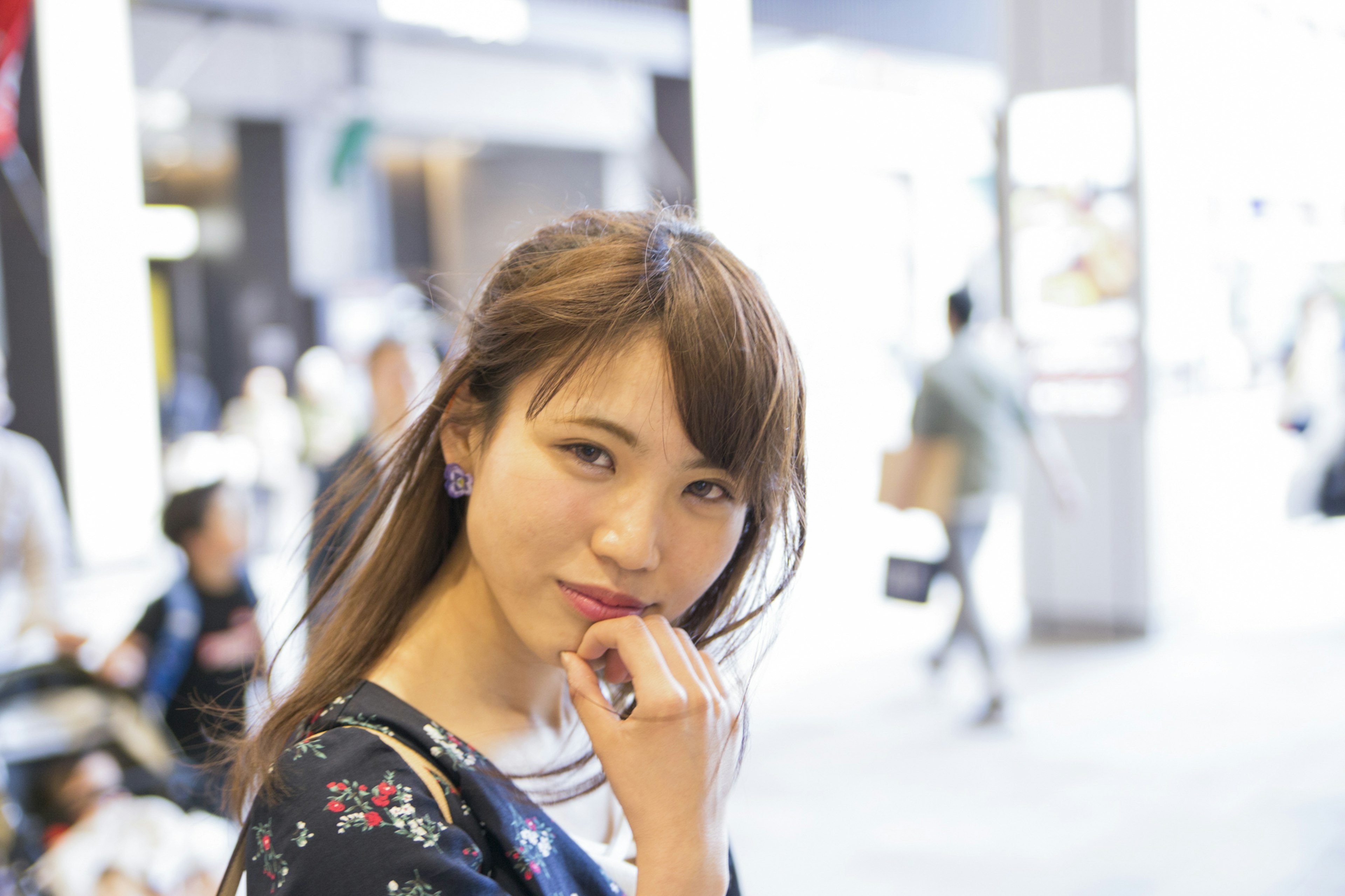 Young woman smiling and looking at the camera in an urban setting