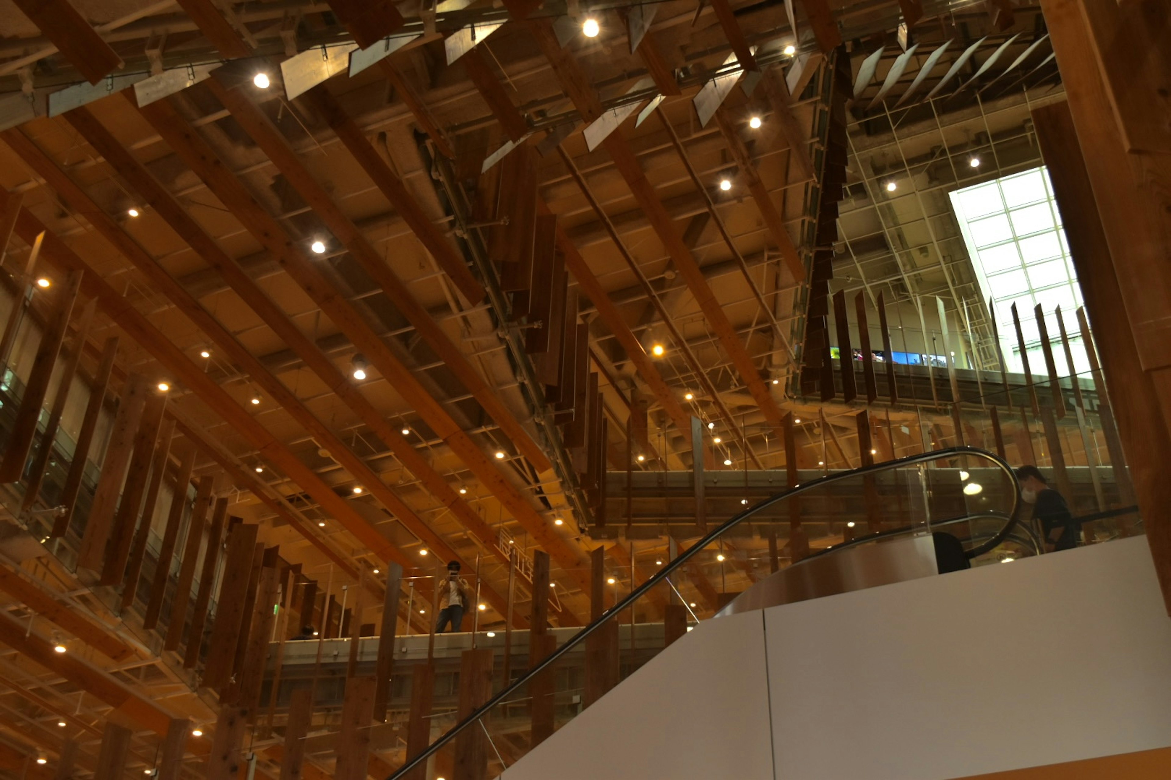 Interior of a modern building featuring wooden beams and bright lighting